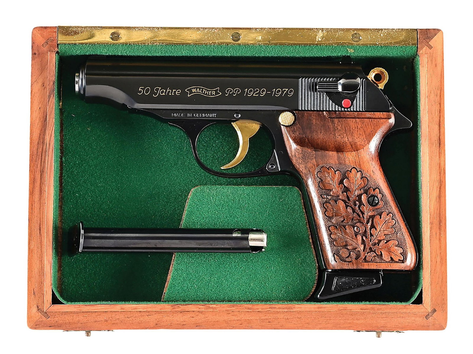 (M) 50 YEAR COMMEMORATIVE FACTROY ENGRAVED WALTHER PP SEMI AUTOMATIC PISTOL.: Only 500 pistols were assembled in 1979. Features the high polish blue finish with gold accents, oak leaf carved walnut grips and engraved with gold fill on both sides of slide. This example is number