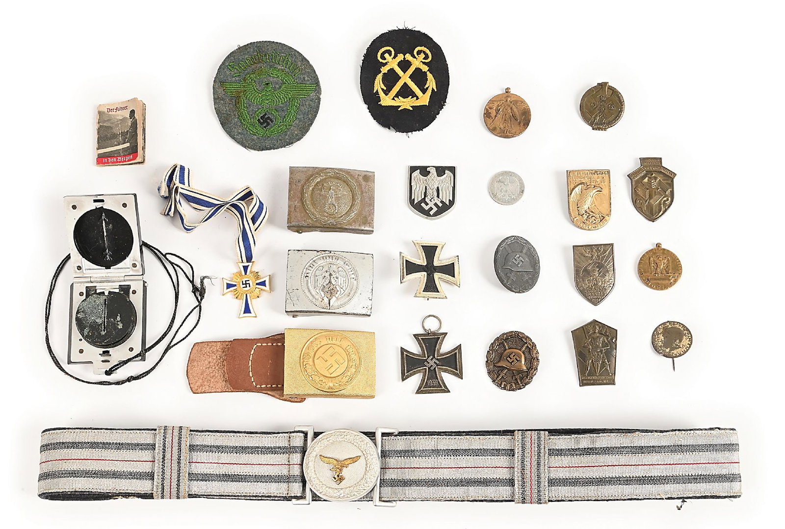 LOT OF MISCELLANEOUS GERMAN WWII INSIGNIA, BADGES, AND BUCKLES.: Miscellaneous German WWII items include and unissued 1940-dated gold finished aluminum "Wasserschutzpolizei" buckle with marked ("1940, Friedrich Linden") leather tab, "26" marked EKI, Luftwaffe