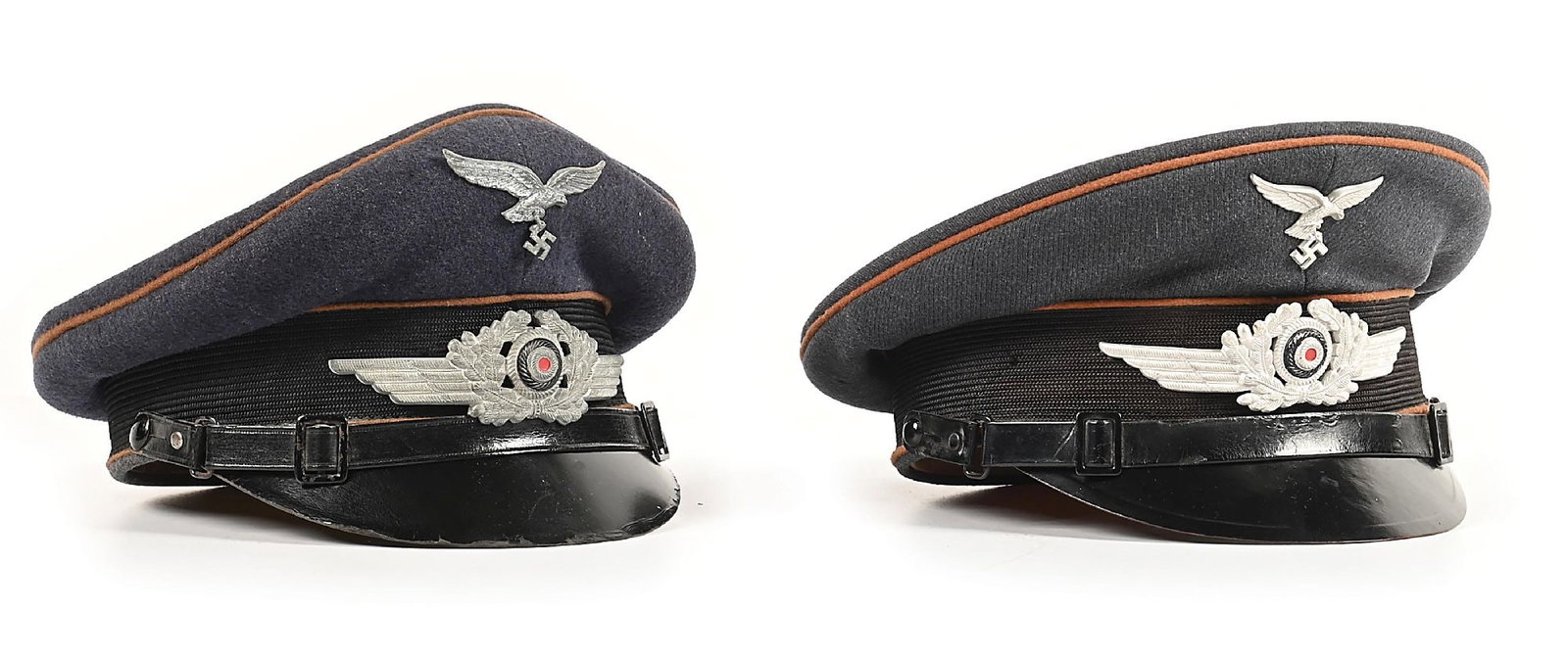 LOT OF 2: GERMAN WWII LUFTWAFFE SIGNAL ENLISTED VISOR CAPS.: Lot contains 2 German WWII Luftwaffe Signal enlisted visor caps: (A) Signal cap has medium brown piping (with a dozen tiny moth nips on the piping which borders the center band), EM chin strap with