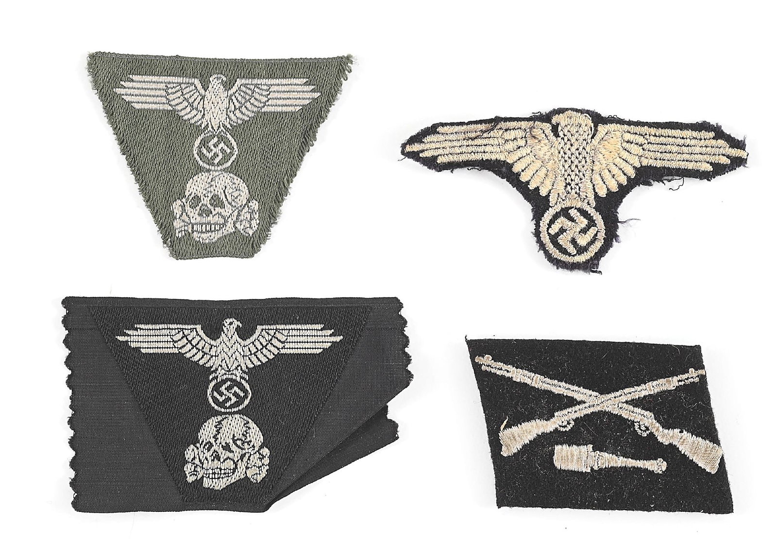 LOT OF 4: THIRD REICH WAFFEN SS INSIGNIA.: Lot contains a Waffen SS sleeve eagle on black wool, a M43 cap eagle/ skull green BeVo trapezoid, a M43 cap eagle/ skull black BeVo trapezoid, and a 36th Waffen SS Panzer Grenadier "Dirlewanger"