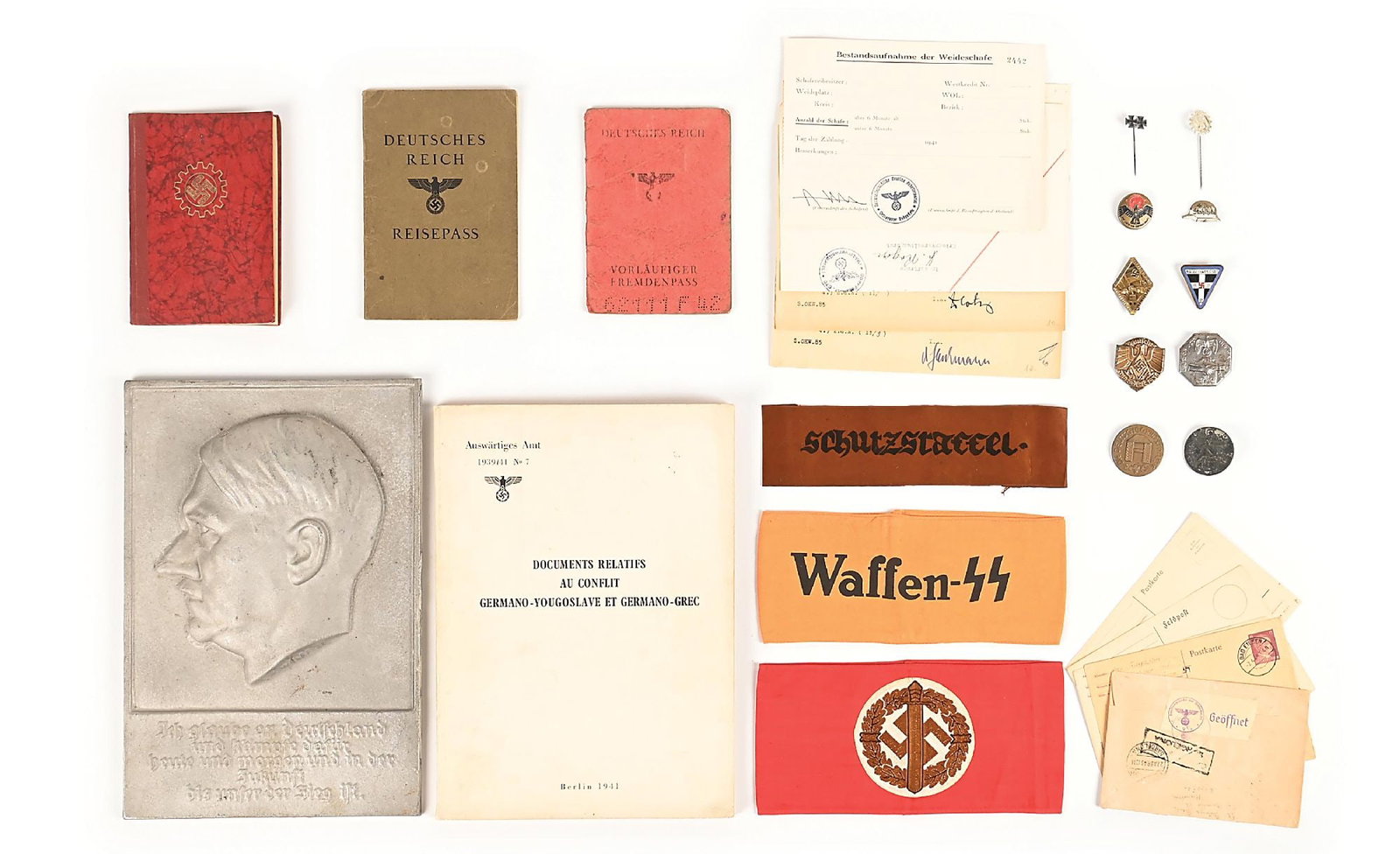 LOT OF MISCELLANEOUS THIRD REICH ARMBANDS, DOCUMENTS, AND METAL PLAQUE.: Lot contains Third Reich armbands (Waffen SS and SA), passes (RAD, Reisepass, and Fremden), messages,a booklet in French about the German 1941 campaign in the Balkans, tinnies, and a 11.5" x 8.5" cast