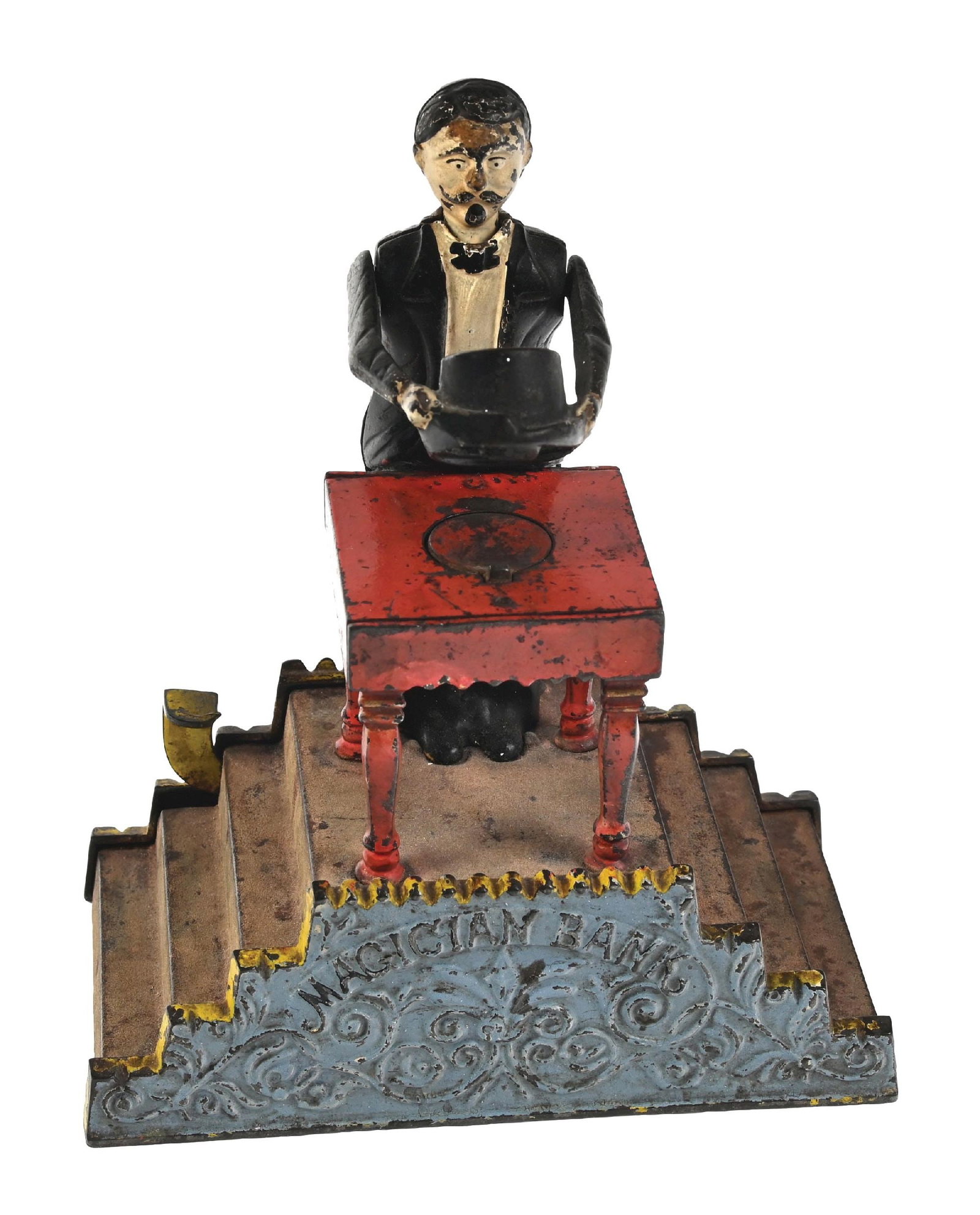 J. & E. STEVENS MAGICIAN BANK: All original with exception of replaced coin trap. Paint loss to forehead. Condition: (Very Good Plus - Excellent). Dimensions: 7" x 3 - 3/4" x 8".
