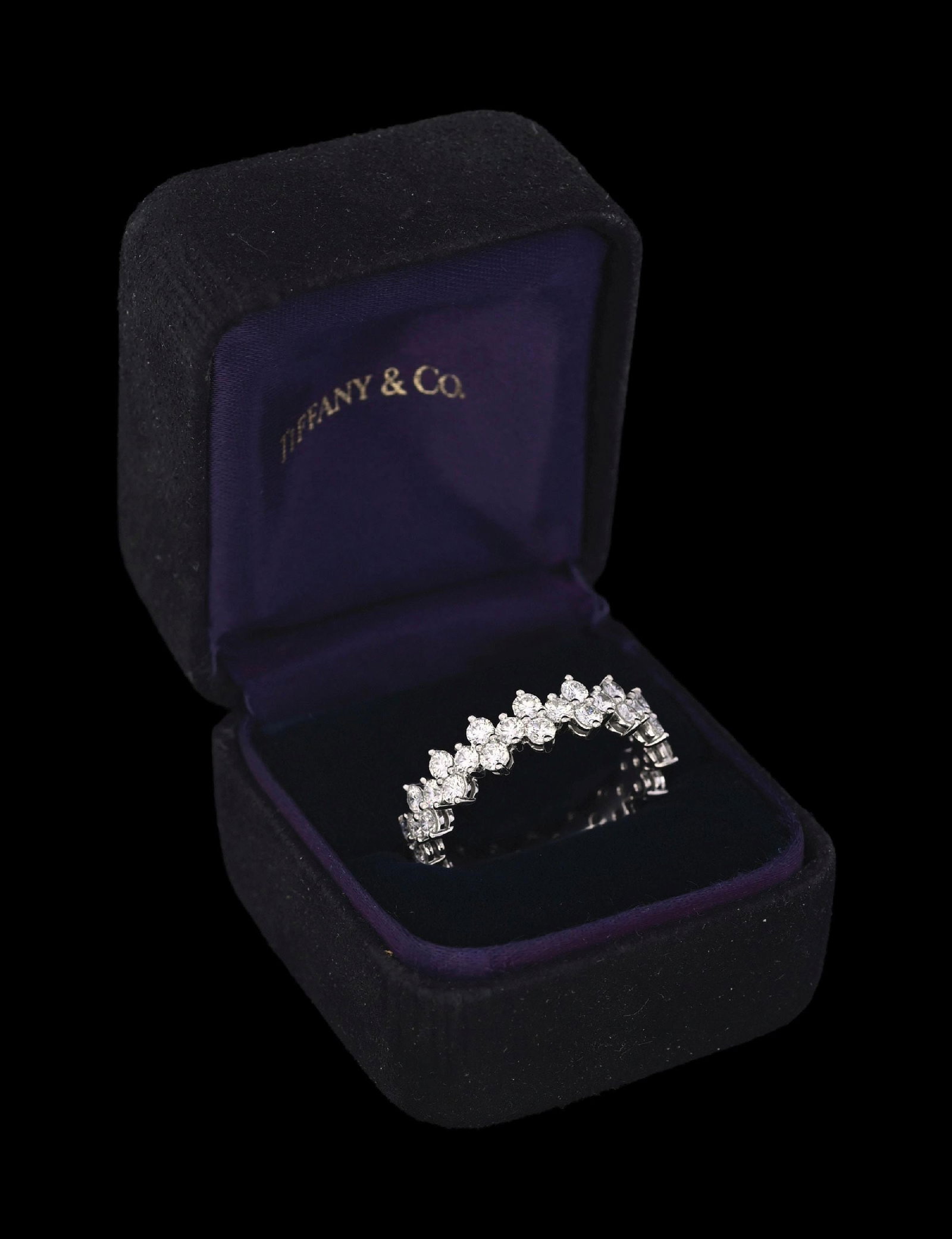 TIFFANY & CO. PLATINUM DIAMOND ETERNITY BAND W/BOX: Ladies' platinum Tiffany & Co. diamond eternity ring/band consisting of 48 round brilliant cut natural diamonds with a total weight of 3.00cts, graded E/F, VS. Gross weight is 7.0 grams. Finger size 9