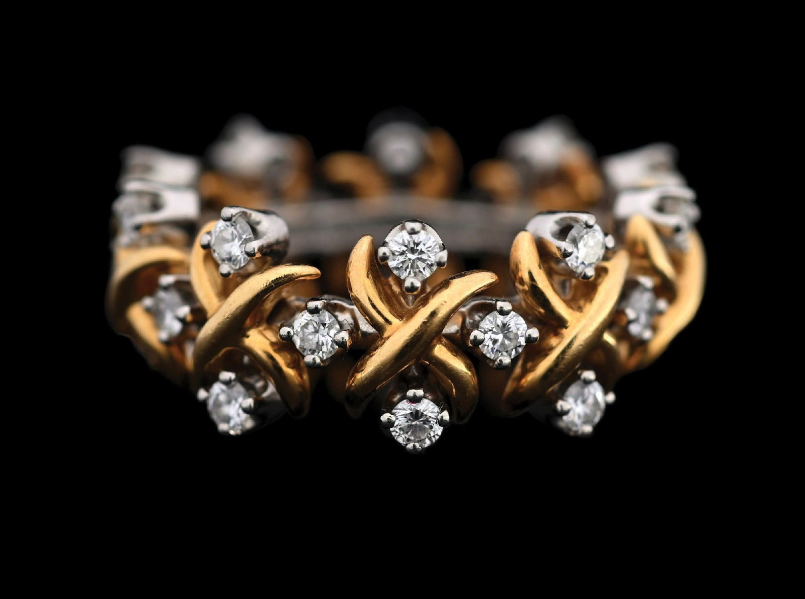 TIFFANY & CO. SCHLUMBERGER STUDIOS PLATINUM AND 18K GOLD DIAMOND X RING: Ladies' Schlumberger Studios for Tiffany & Co. diamond "X" band in platinum and 18k yellow gold, set with 30 round brilliant cut natural diamonds measuring approximately 2.1mm each, with an estimated 