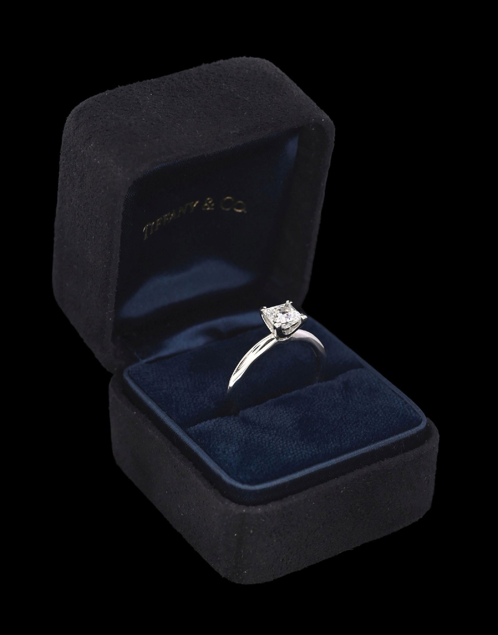 TIFFANY & CO. PLATINUM PRINCESS CUT DIAMOND RING W/BOX: Ladies' platinum Tiffany & Co. diamond engagement ring consisting of 1 princess cut natural diamond weighing 0.92cts, graded F, VS1. Gross weight is 4.1 grams. Finger size 6-1/4. Width measures 6mm at