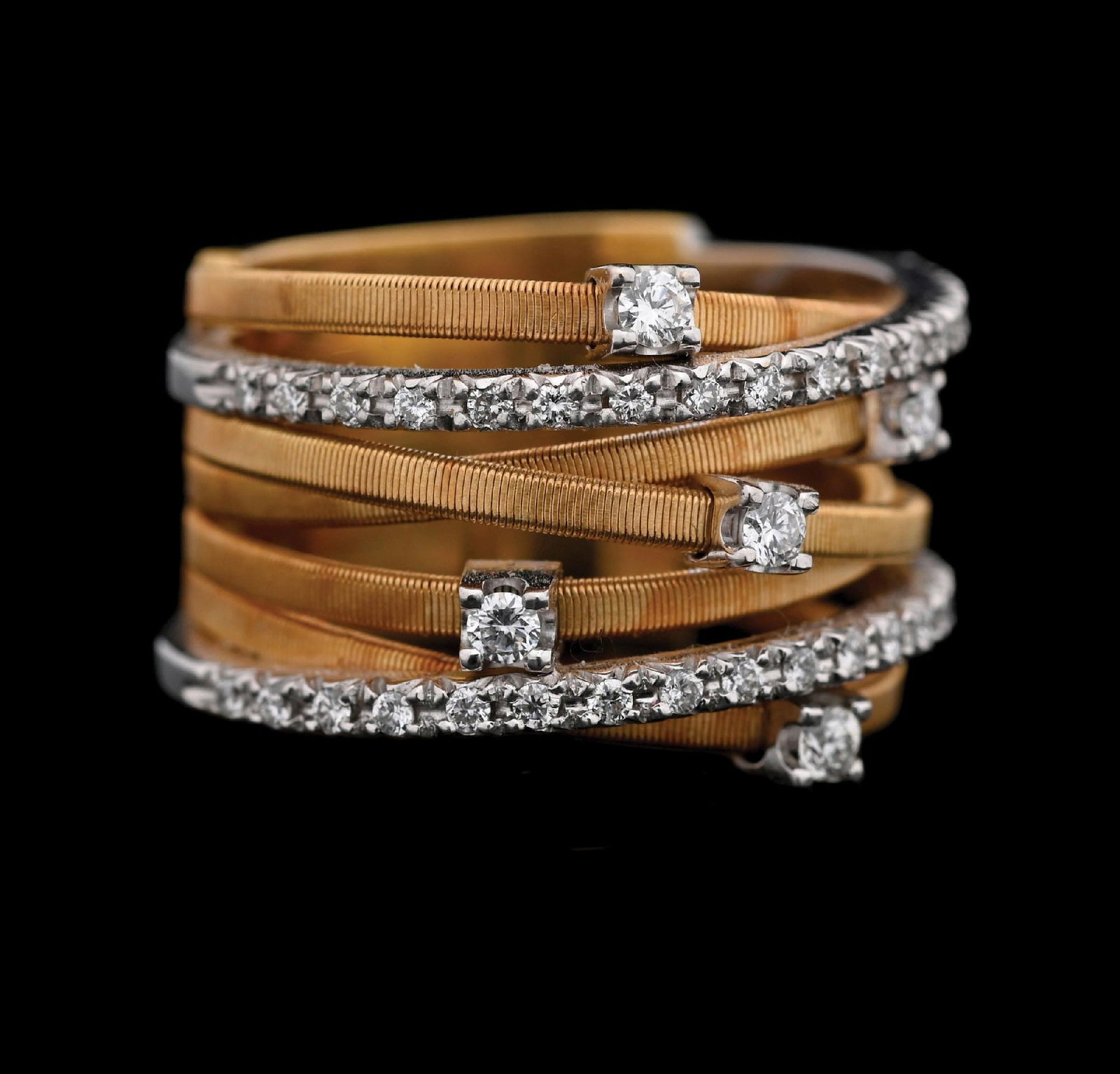 18K 2-TONE MARCO BICEGO 7-STRAND DIAMOND BAND: Ladies' 18k two-tone white and yellow gold seven-strand wide diamond band set with 38 round faceted natural diamonds with an estimated total weight of 0.50cts. Marked inside "Made in Italy, 750" with 