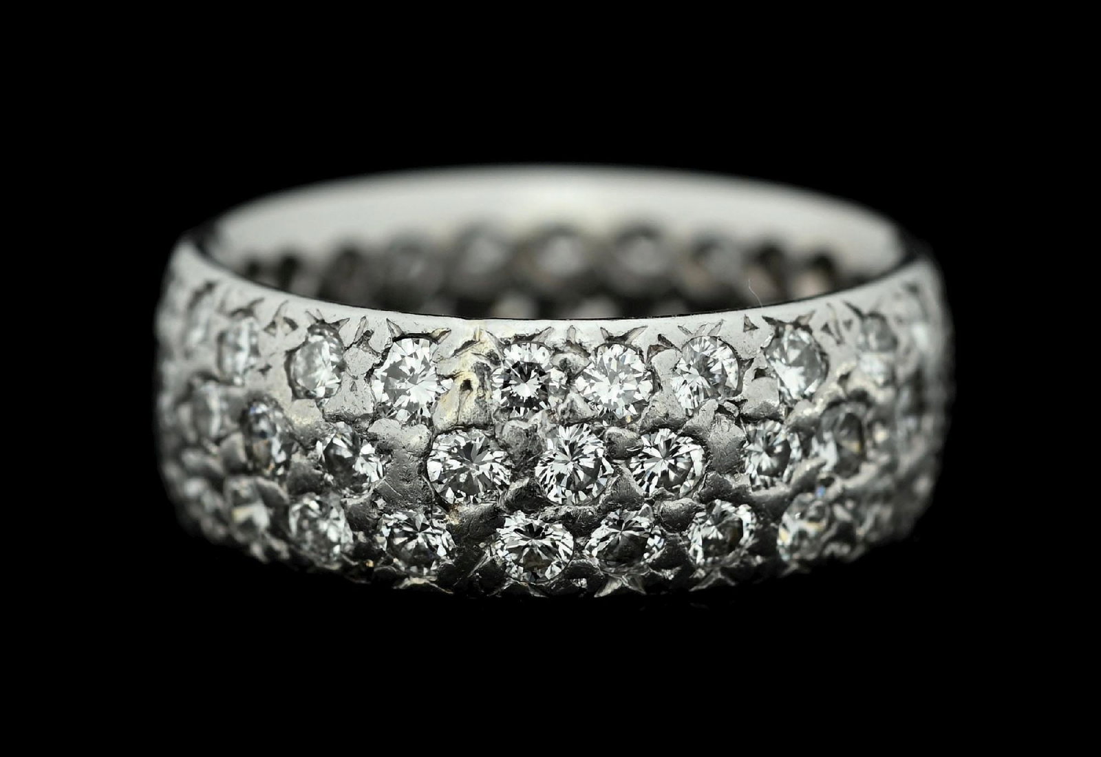 PLATINUM PAVE-SET 2CT TW DIAMOND BAND: Ladies' platinum pave-set diamond band consisting of 72 round brilliant cut diamonds measuring approximately 2mm each, with an estimated total weight of 2.00cts. Width measures 7mm. Ring size 5.