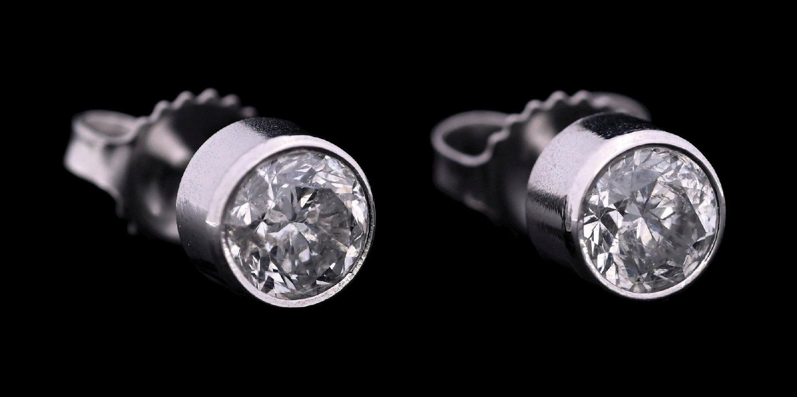 14K WHITE GOLD DIAMOND STUD EARRINGS W/REPORT: 14k white gold bezel-set diamond (1.47ctw) stud earrings accompanied by an original GGA appraisal report with an ERRV of $8,920.00 (See additional website images of report for specifications). Width m