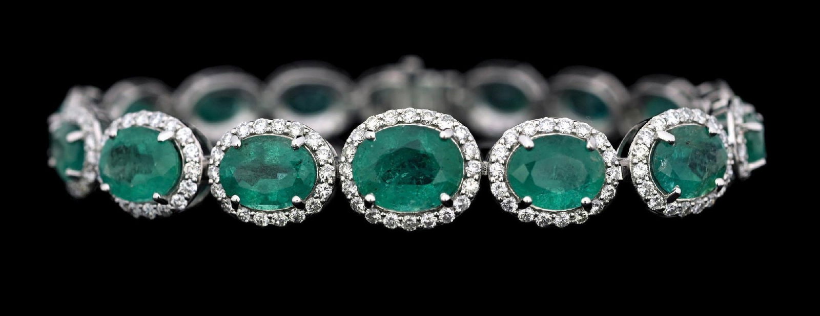 PLATINUM EMERALD & DIAMOND BRACELET W/REPORT: Ladies' platinum graduated emerald (19.10ctw) and diamond (3.91ctw) bracelet accompanied by an original AIGL appraisal report with an ERRV of $43,657.00 (See additional website images of report for sp