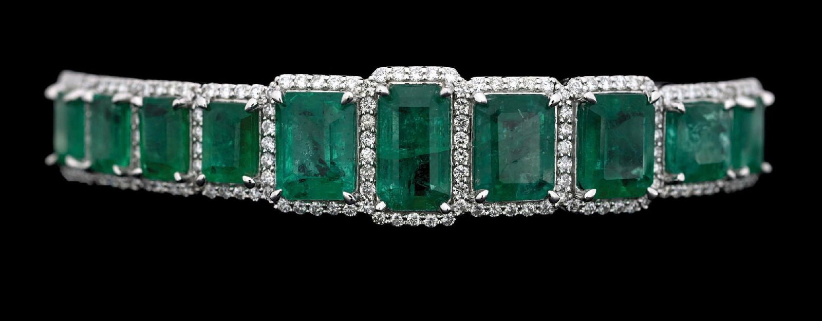 PLATINUM EMERALD & DIAMOND BANGLE BRACELET W/REPORT: Ladies' platinum emerald (15.87ctw) and diamond (1.43ctw) bangle bracelet accompanied by an original AIGL appraisal report with an ERRV of $56,650.00 (See additional website images of report for speci