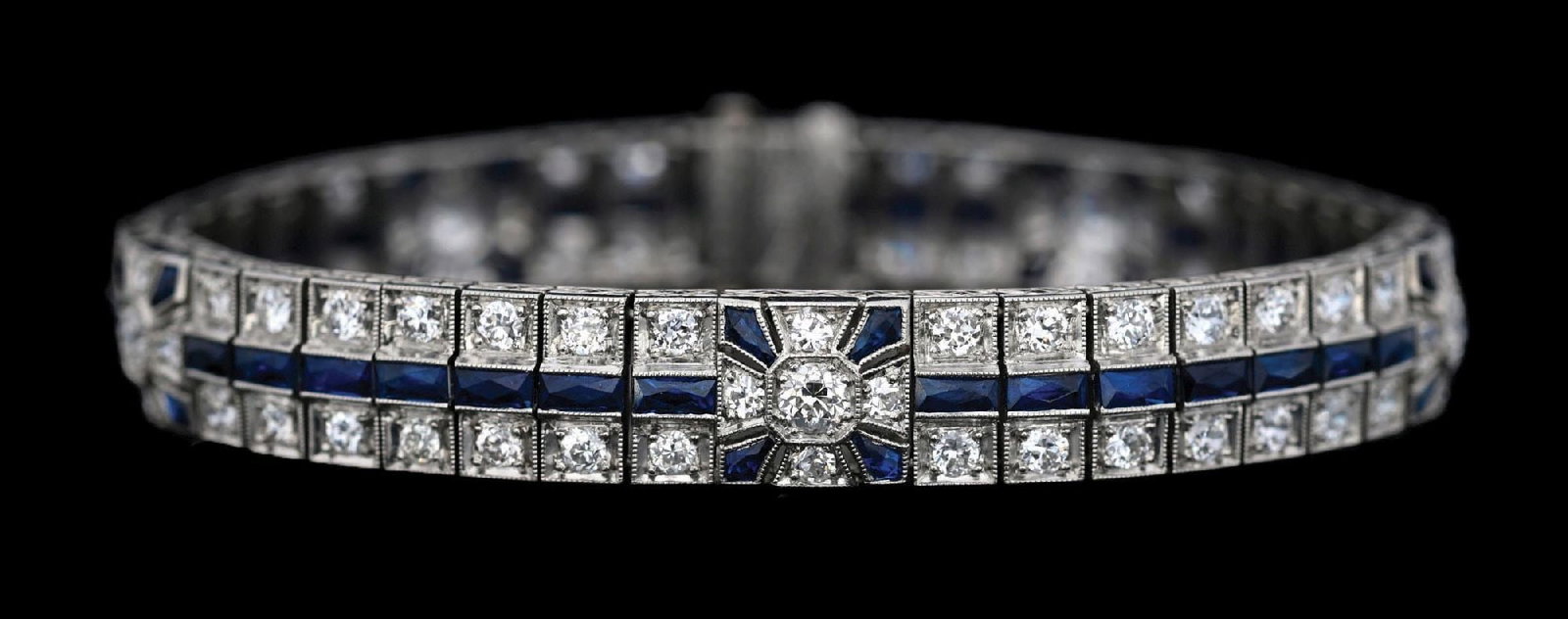 ART DECO PLATINUM DIAMOND & BLUE SAPPHIRE BRACELET: Ladies' platinum art-deco diamond and sapphire bracelet consisting of 95 round cut natural diamonds with a total weight of 7.00cts and 55 French cut blue sapphires with a total weight of 5.75cts. Gros