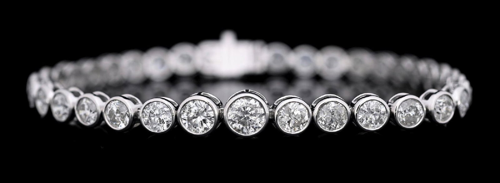 PLATINUM BEZEL-SET DIAMOND BRACELET W/REPORT: Ladies' platinum bezel-set diamond (10.22ctw) bracelet accompanied by an original AIGL appraisal report with an ERRV of $49,687.00 (See additional website images of report for specifications). Width m