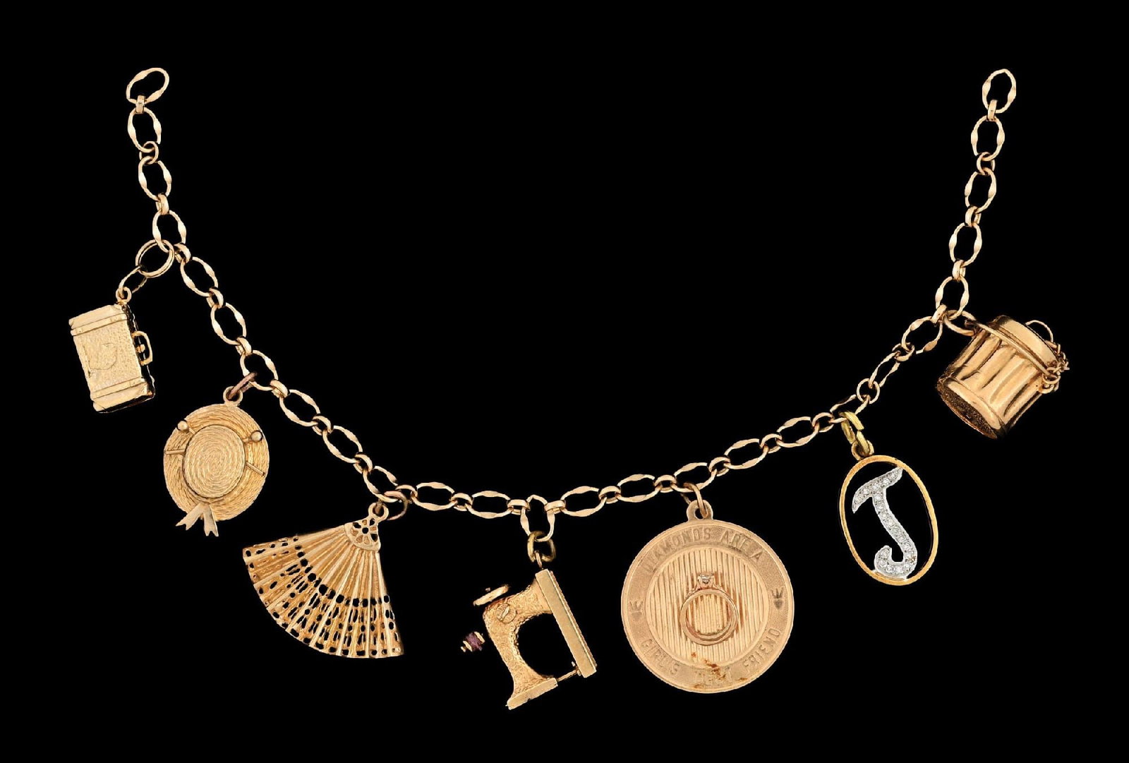 VINTAGE GOLD CHARM BRACELET: Ladies' gold bracelet with 7 charms. Bracelet is unmarked, untested and missing clasp. One charm marked "18K", four charms marked "14K", one marked "10K" and one unmarked appearing to be 14k gold, unt