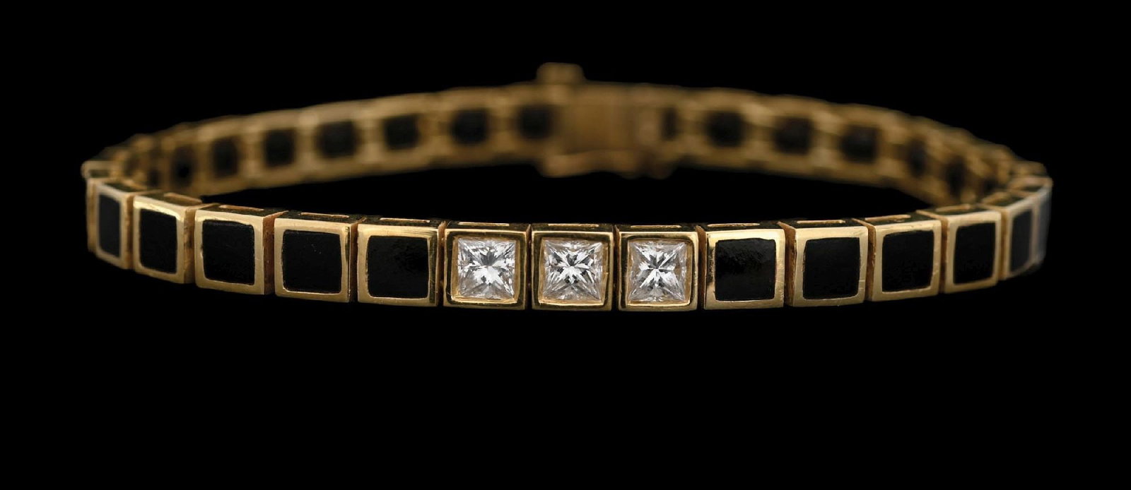 18K GOLD ONYX & PRINCESS-CUT CZ TENNIS BRACELET: Ladies' 18k yellow gold black onyx and princess-cut cubic zirconia bracelet. Length: 7-3/8". Width: 6mm. Gross weight: 28.2 grams. Marked "18K". Condition: (Very Good-Excellent). Dimensions: