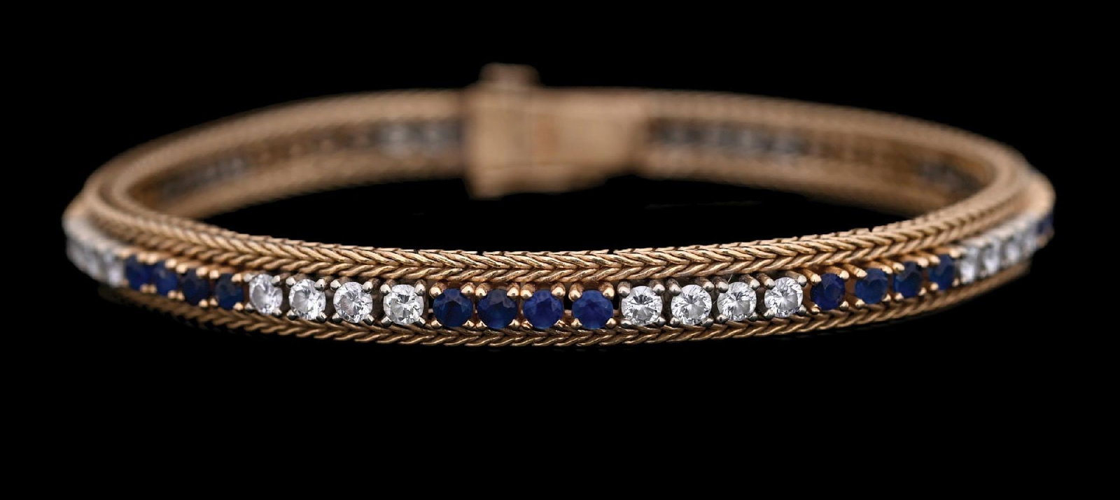 14K GOLD SAPPHIRE & DIAMOND TENNIS BRACELET: Ladies' 14k yellow gold sapphire and diamond bracelet set with 32 round faceted diamonds and 31 round faceted blue sapphires (one missing from setting). Width: 6mm. Length: 7". Gross weight: 20.4 gram