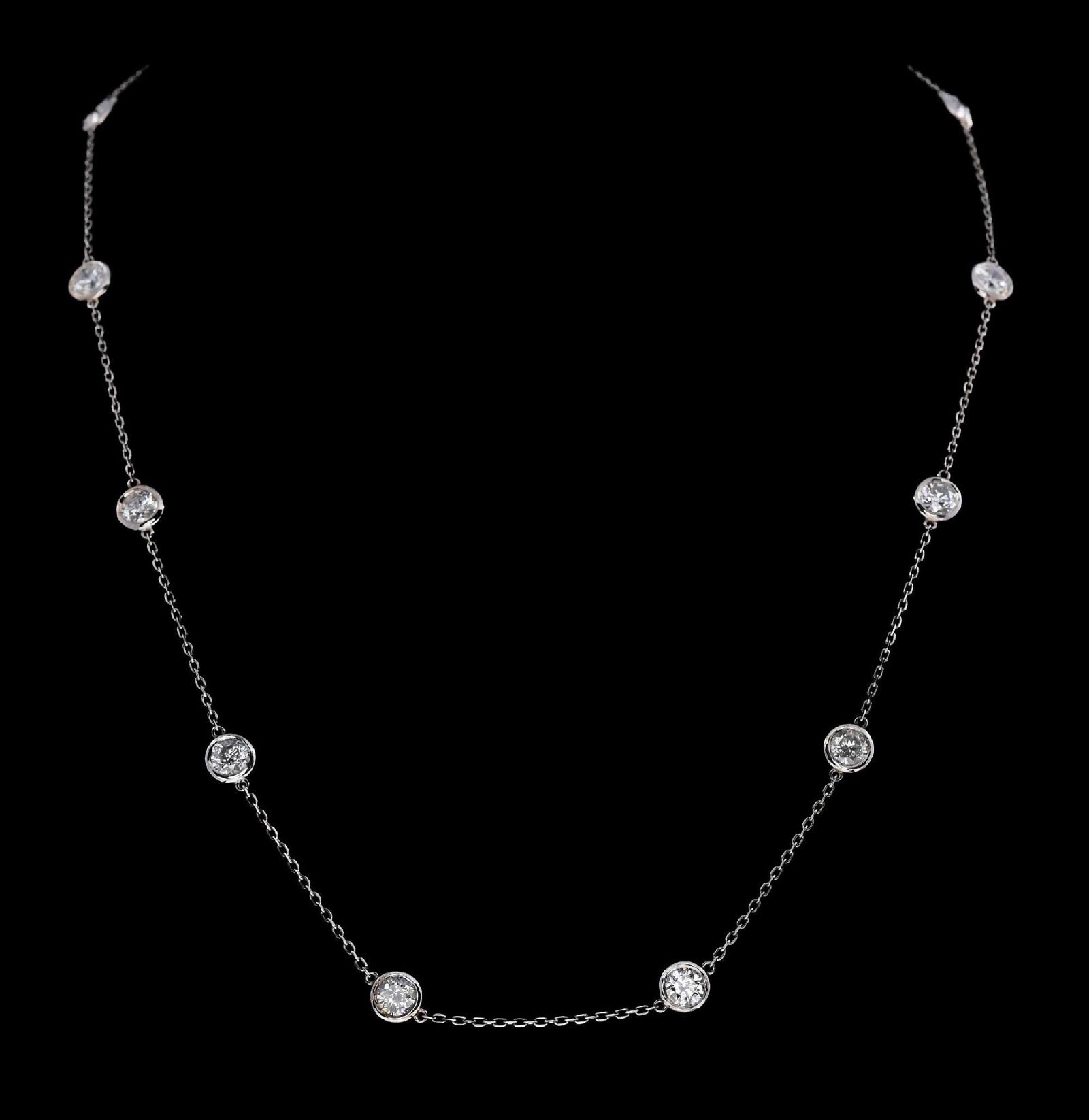 14K WHITE GOLD DIAMOND STATION NECKLACE W/REPORT: Ladies' 14k white gold diamond (3.23ctw) station necklace accompanied by an original GGA appraisal report with an ERRV of $16,480.00 (See additional website images of report for specifications). Width