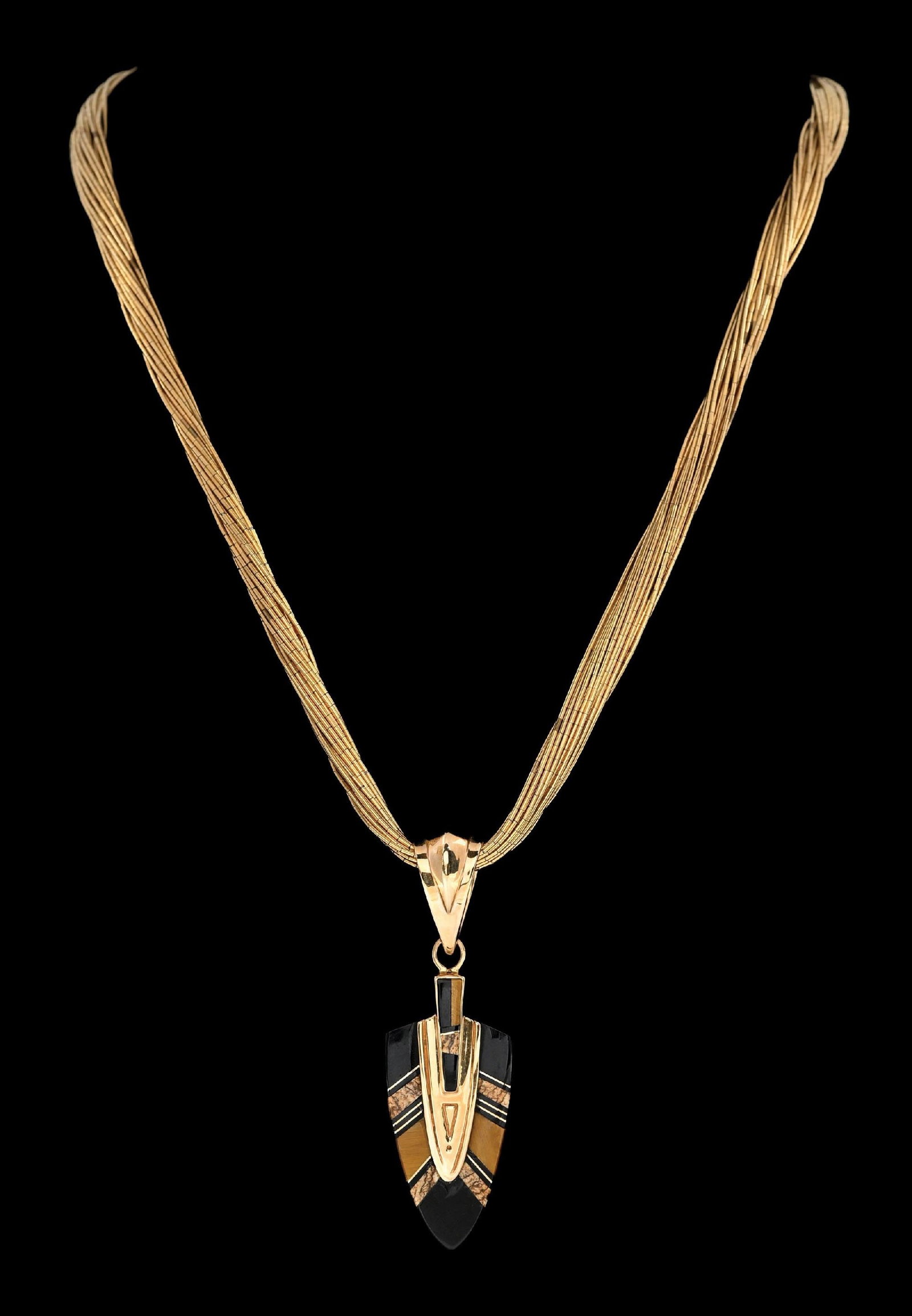 14K GOLD ARROWHEAD PANDANT ON LONG GF MULTI-STRAND NECKLACE: Ladies' 14k yellow gold black onyx and jasper/agate arrowhead design pendant on a multi-strand yellow gold-filled chain. Pendant measures 2-1/2" in length. Chain length: 30". Gross weight: 45.9 grams.