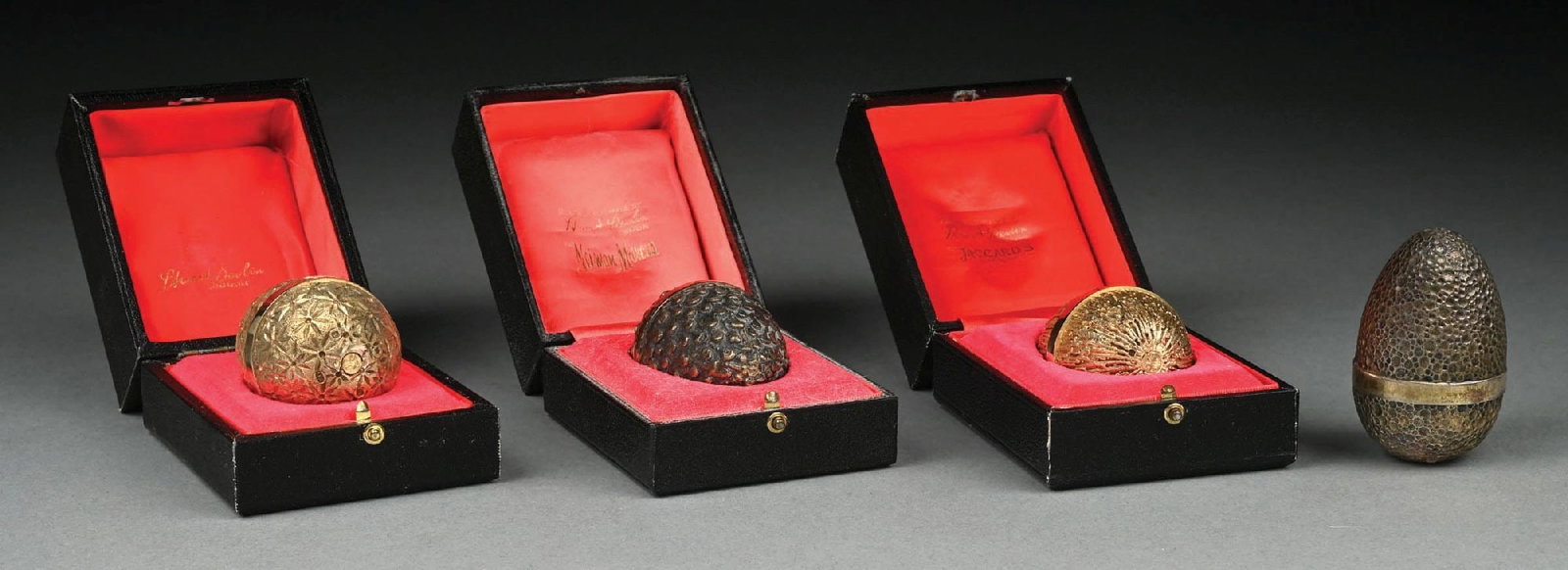 FOUR ENGLISH SILVER SURPRISE EGGS: Stuart Devlin London, all with various textured surfaces, the first with a bird among leaves and pearl blossoms (1977); the second, gilt, with a mouse in a piece of cheese (1976); the third also gilt,