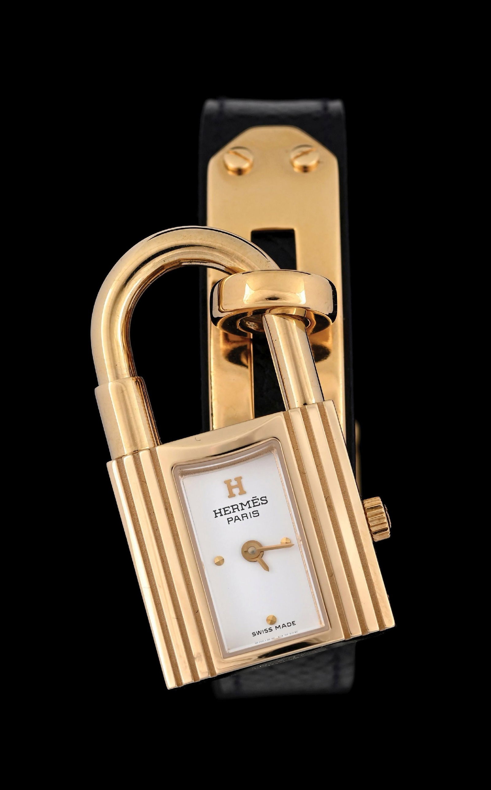 HERMES GOLD KELLY PADLOCK WATCH ON LEATHER W/BOX: Ladies' Hermes 20mm Kelly "Padlock" wristwatch in yellow gold on steel with white dial and black stitched strap. The watch is in excellent unworn condition, running properly, with a new battery instal
