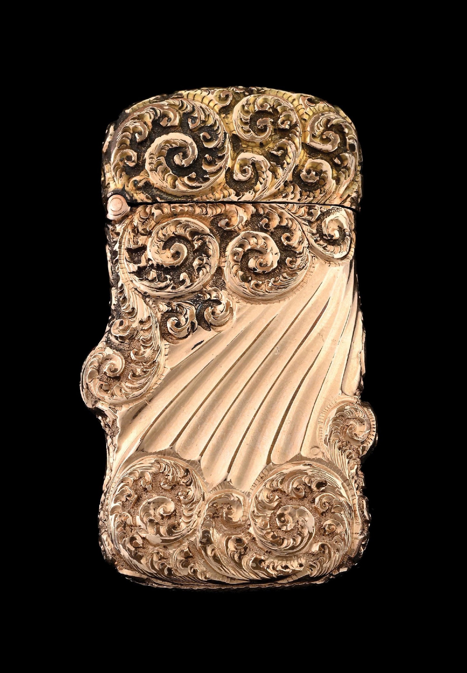 12K GOLD MATCH SAFE: Beautiful scrolling and leaf design. Tests for 12K gold. 27.9 grams. From the portfolio of an avid and dedicated collector. Condition: (Excellent). Dimensions: 1 - 1/4" X 2 - 1/2".