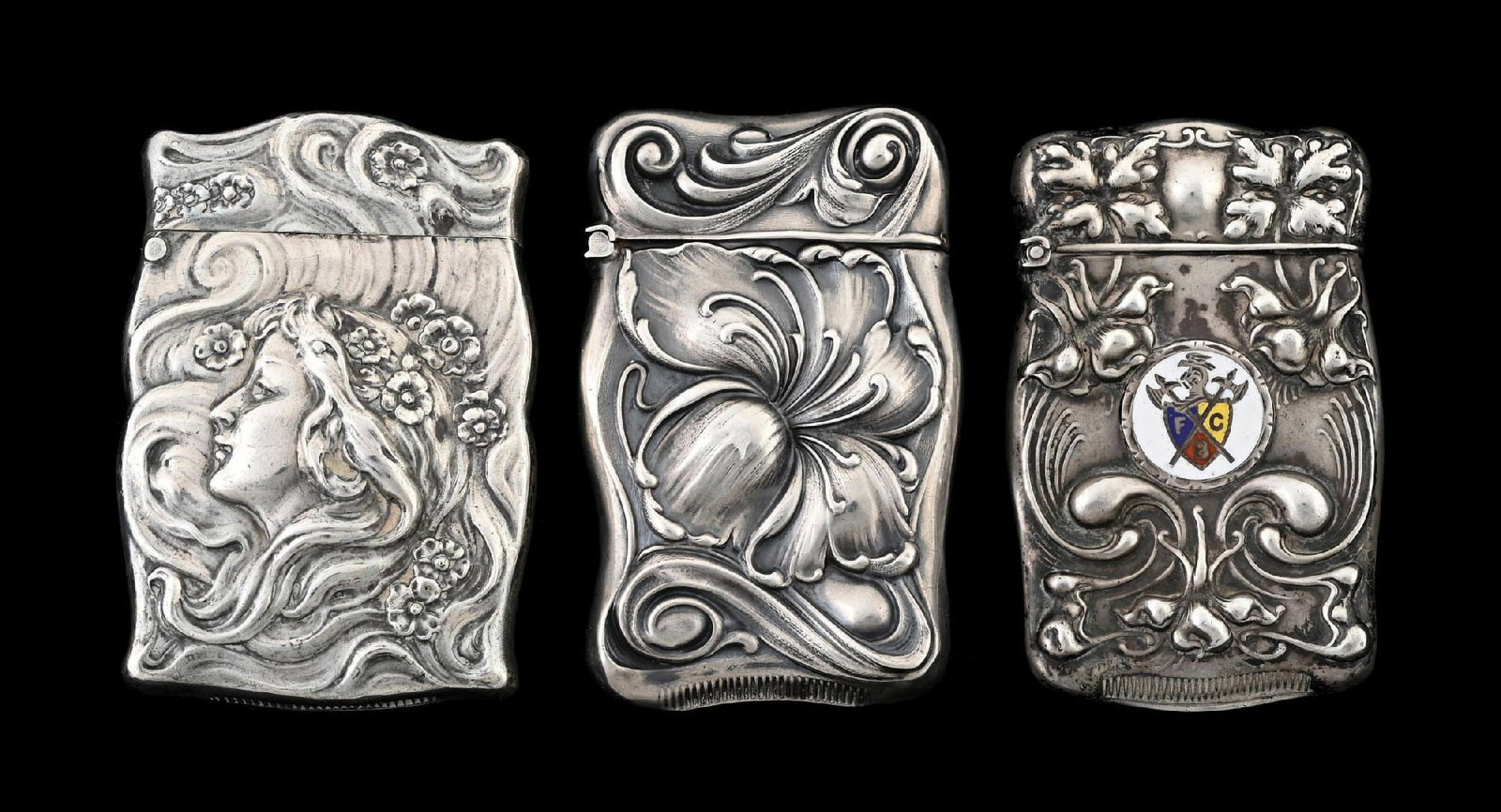 COLLECTION OF 3: STERLING SILVER MATCH SAFES: One with Victorian lady, one floral and one fraternal. From the portfolio of an avid and dedicated collector. Condition: Dimensions: Largest: 1 - 3/4" x 2 - 1/2".