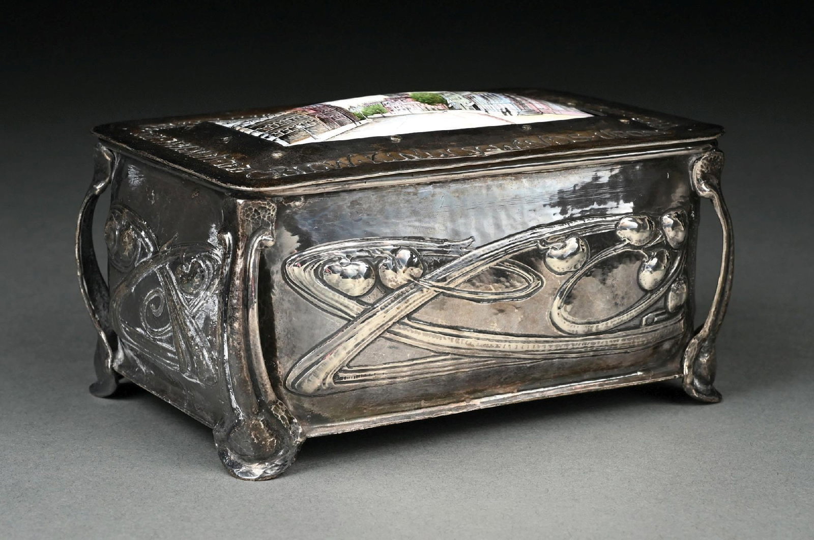 AN ENGLISH ART NOUVEAU SILVER DESK BOX: Ramsden and Carr, London 1901, the rectangular body chased with stylized tendrils, the lid with an inscription around an enamel plaque with a view of Oxford. Length: 5-1/2". Weight: 13.3 ozt.