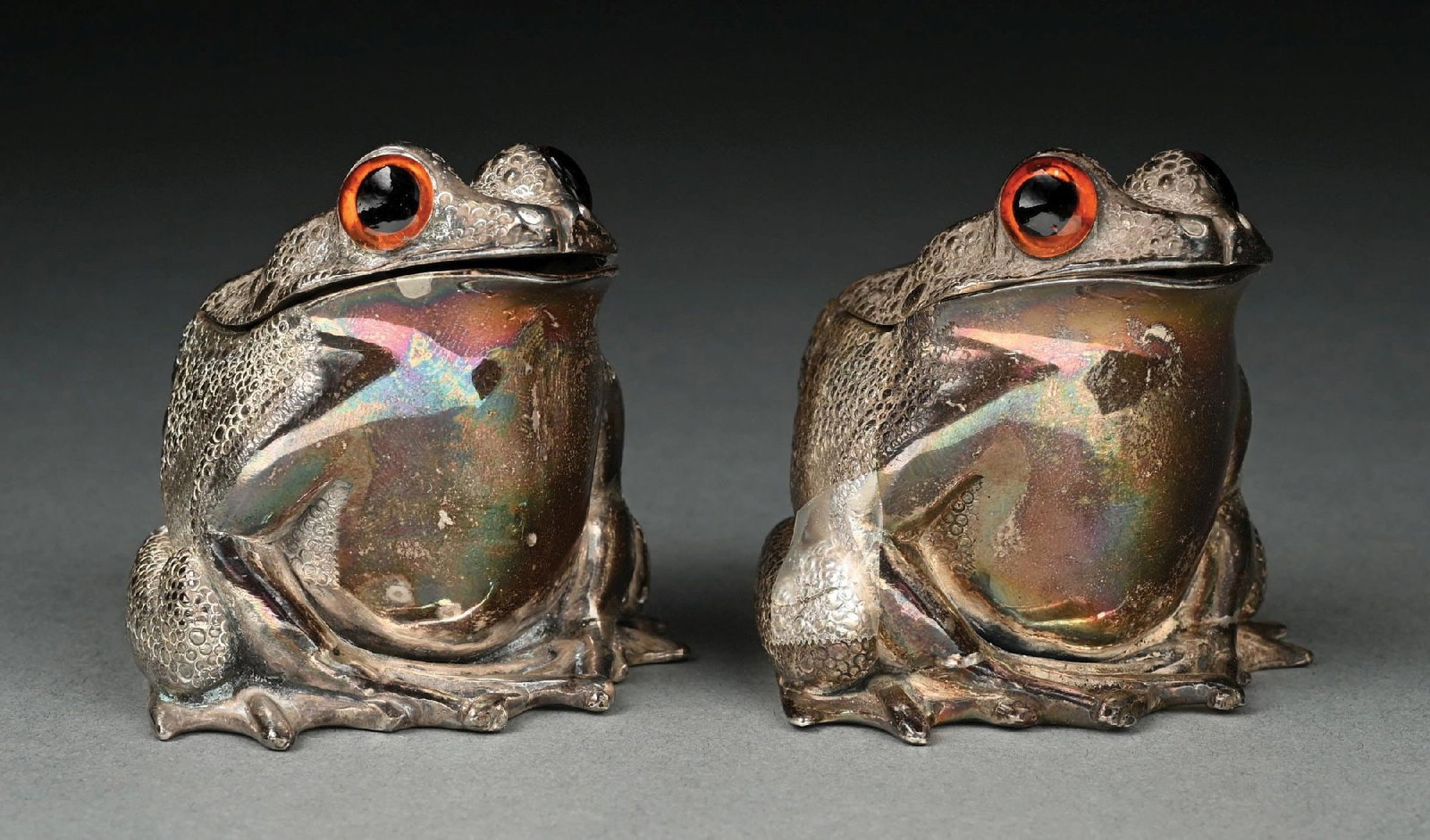 A PAIR OF ENGLISH SILVER FIGURAL INKWELLS: Aspreys, London 1967, cast and chased in the form of toads, with hinged heads. Height: 2-3/4". Total weight: 26.4 ozt. Condition: Dimensions: