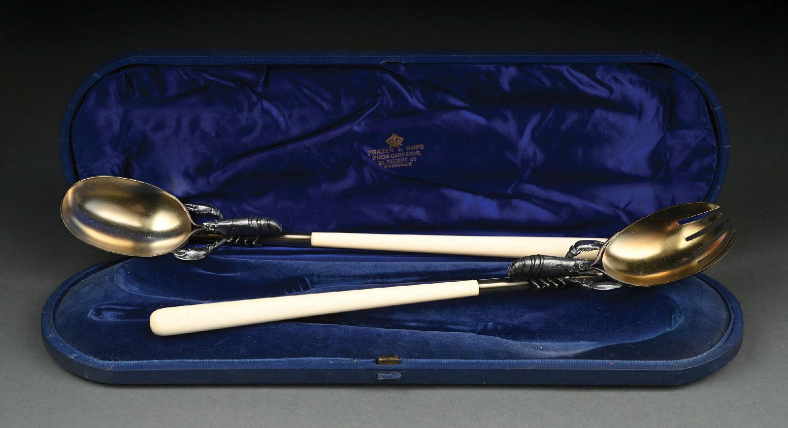 FRAZER & HAWS OF LONDON STERLING SILVER "LOBSTER" PATTERN SALAD SERVING SET IN ORIGINAL BOX: Original fitted box. Gilt silver. Full English hallmarks. Gross weight (including handles): 9.5 ozt Condition: (Excellent). Dimensions: