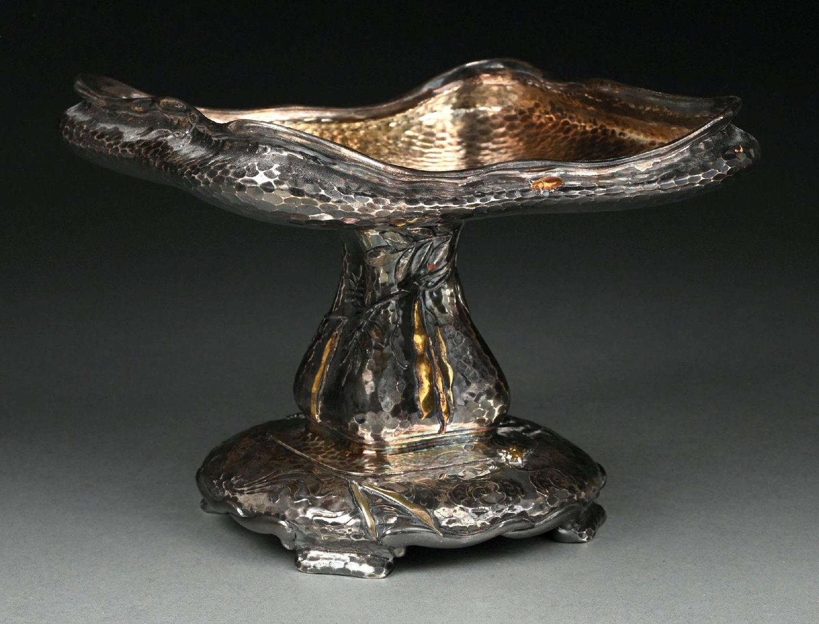 A TIFFANY STERLING AND OTHER METALS COMPOTE: With a square top with a low incurved rim, gourd-shaped stem and circular foot set with a cast spider, beetles and leaves on a hammer finish surface. Diameter of top: 8-1/4". Weight: 32 ozt.