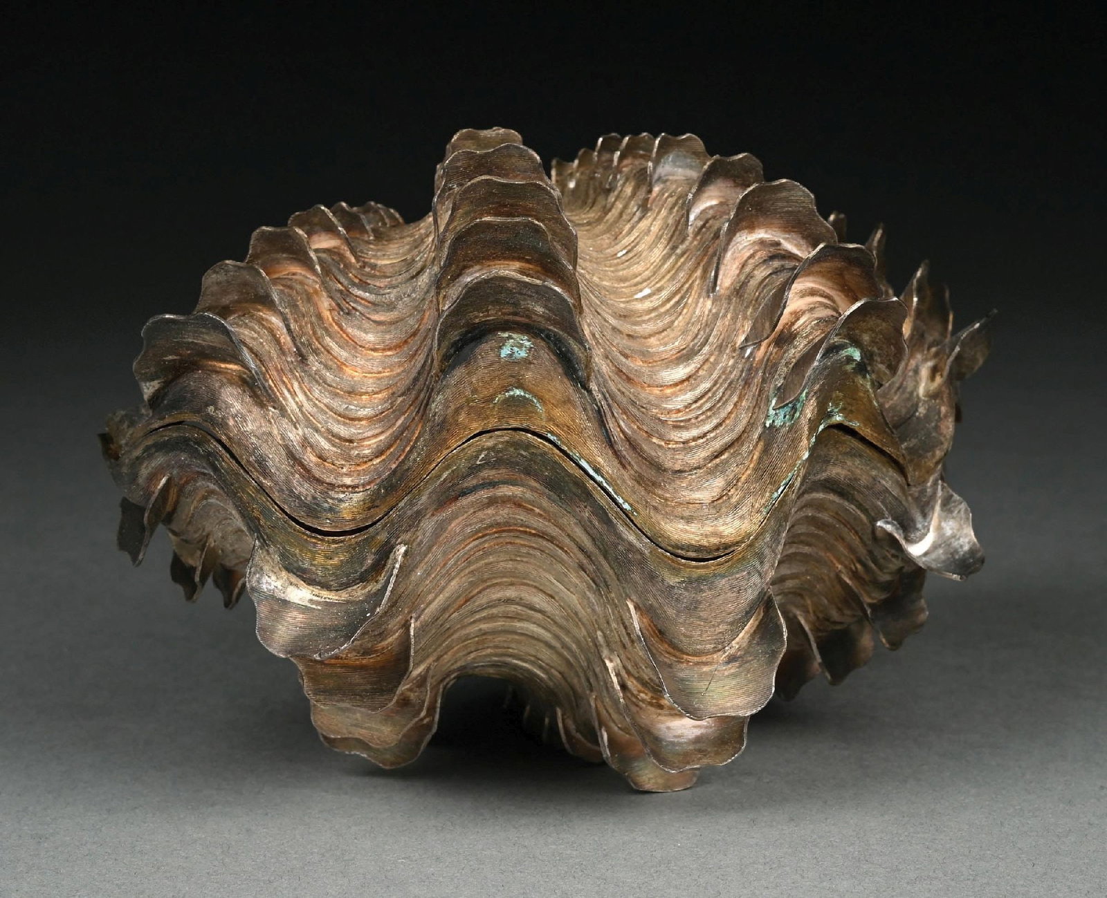A STERLING CAVIAR DISH IN THE FORM OF A GIANT CLAM: Realistically cast and chased with to halves forming a base and lid. Marked 925. Length: 7-1/2". Weight: 32.5 ozt. Condition: Dimensions: