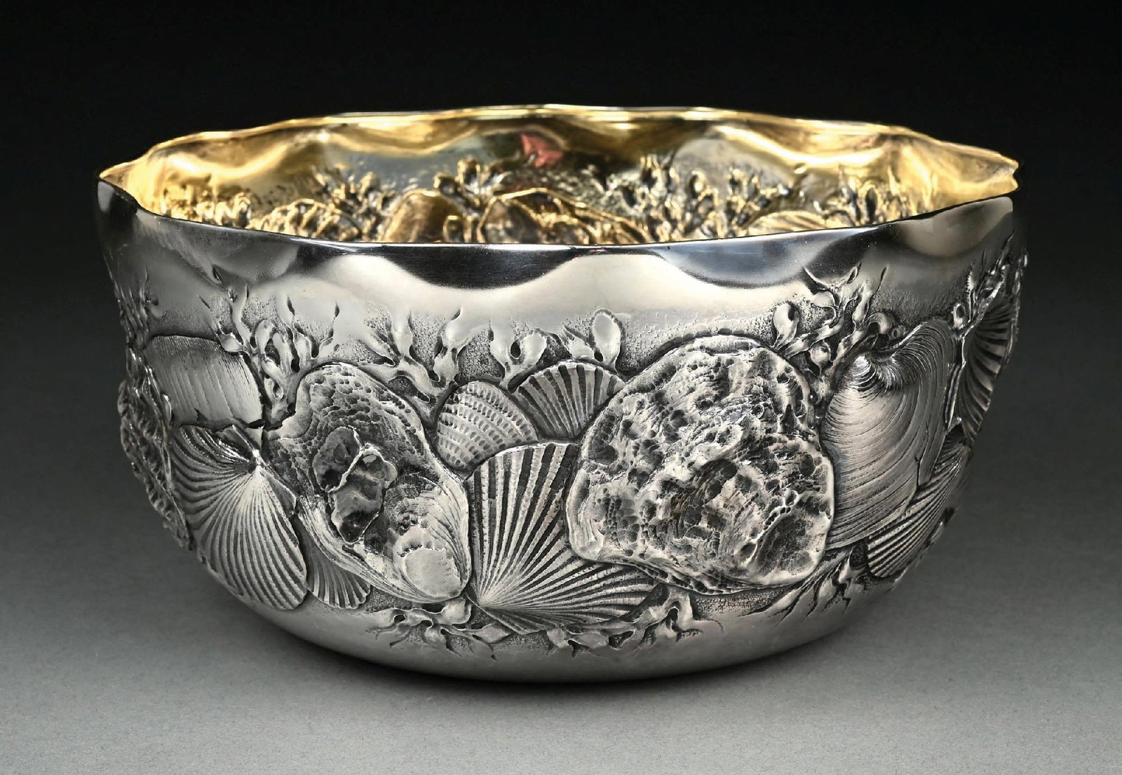 A WHITING STERLING MARINE-THEME CENTER BOWL: 19th century. The tall sides chased with clam, oyster and scallop shells amid seaweed, the interior gilt. Diameter: 9-1/2". Weight: 23.1 ozt. Condition: Dimensions: