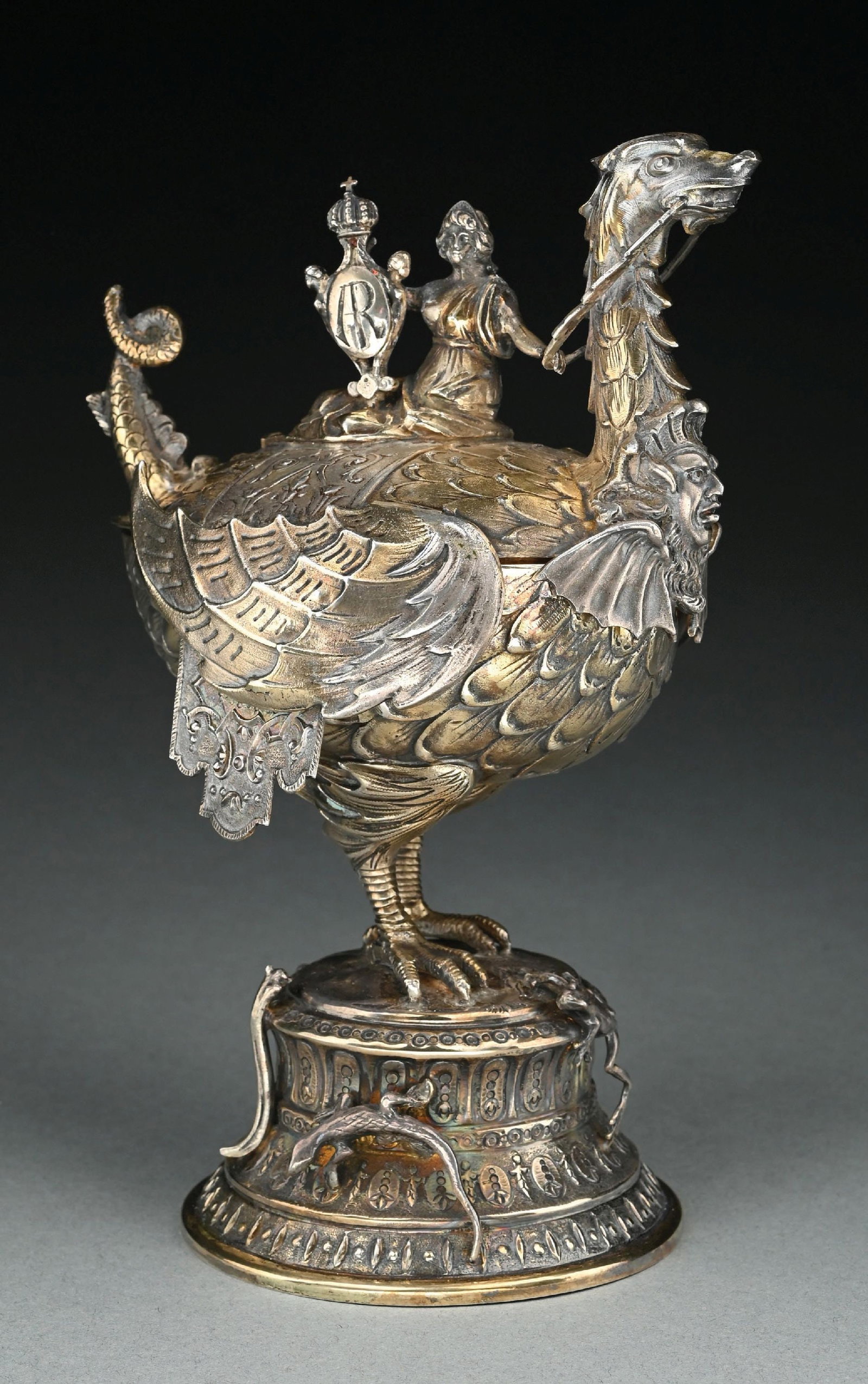 A CONTINENTAL SILVER COVERED CUP: Neresheimer, Hanau, in the form of a fantastical beast with a winged, egg-shaped body with a dragon head and bird feet on a chased base. Height: 8-3/4". Weight: 28.7 ozt. Condition: Dimensions: