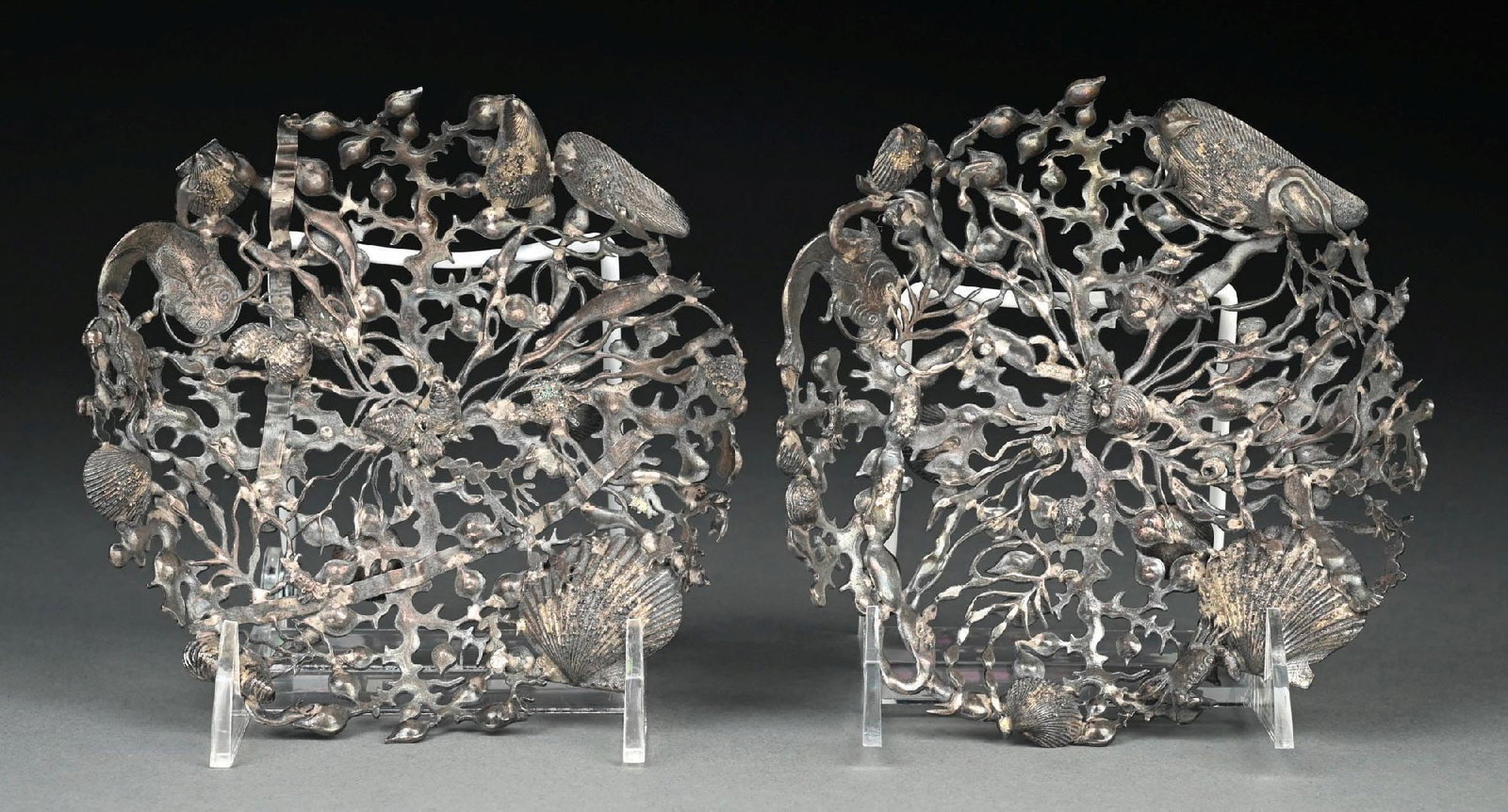 A PAIR OF GORHAM STERLING NARRAGANSETT PATTERN BON BON DISHES: 1886. Each formed as a pierced circle of cast and chased seaweed and various shells and a fish, and on three small clam shell feet. Diameter: 6-1/8". Total weight: 12.2 ozt. Condition: Dimensions: