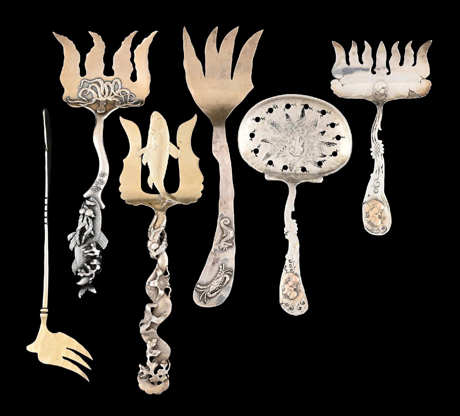 A GROUP OF SHIEBLER STERLING SARDINE FORKS AND A SCOOP: The first with a curved stem, octopus on the gilt tines and with a cast fish at the end; the second with a curved stem and cast seaweed and starfish, the gilt tines with a fish; the third with a hamme