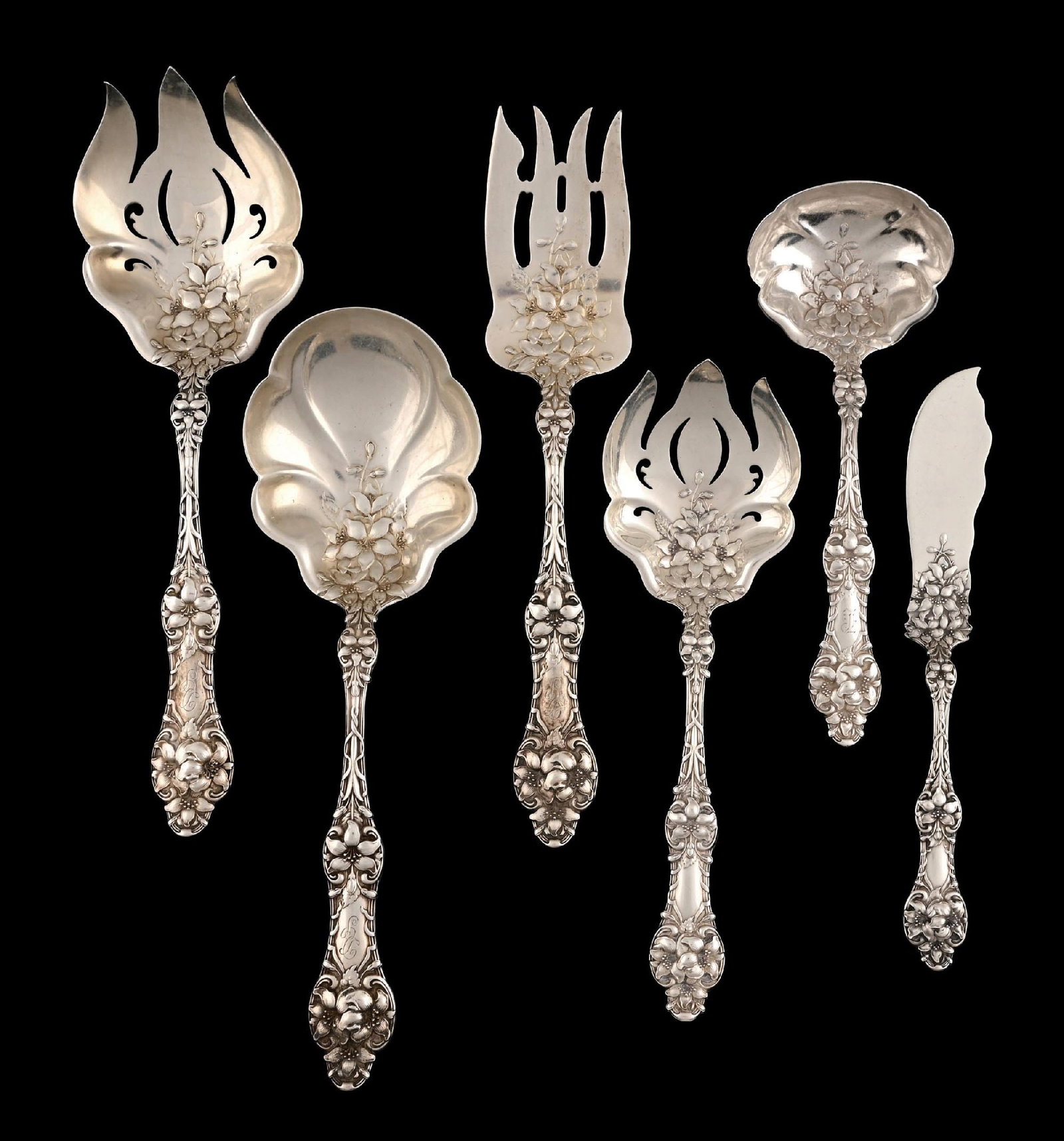 6 ALVIN STERLING ORANGE BLOSSOM PATTERN SERVING PIECES: Including three forks in different sizes with pierced and barred tines, a spoon with a shaped lobed bowl, a butter knife, and a gravy ladle. Length of longest: 9". Total weight: 16.3 ozt. Condition: