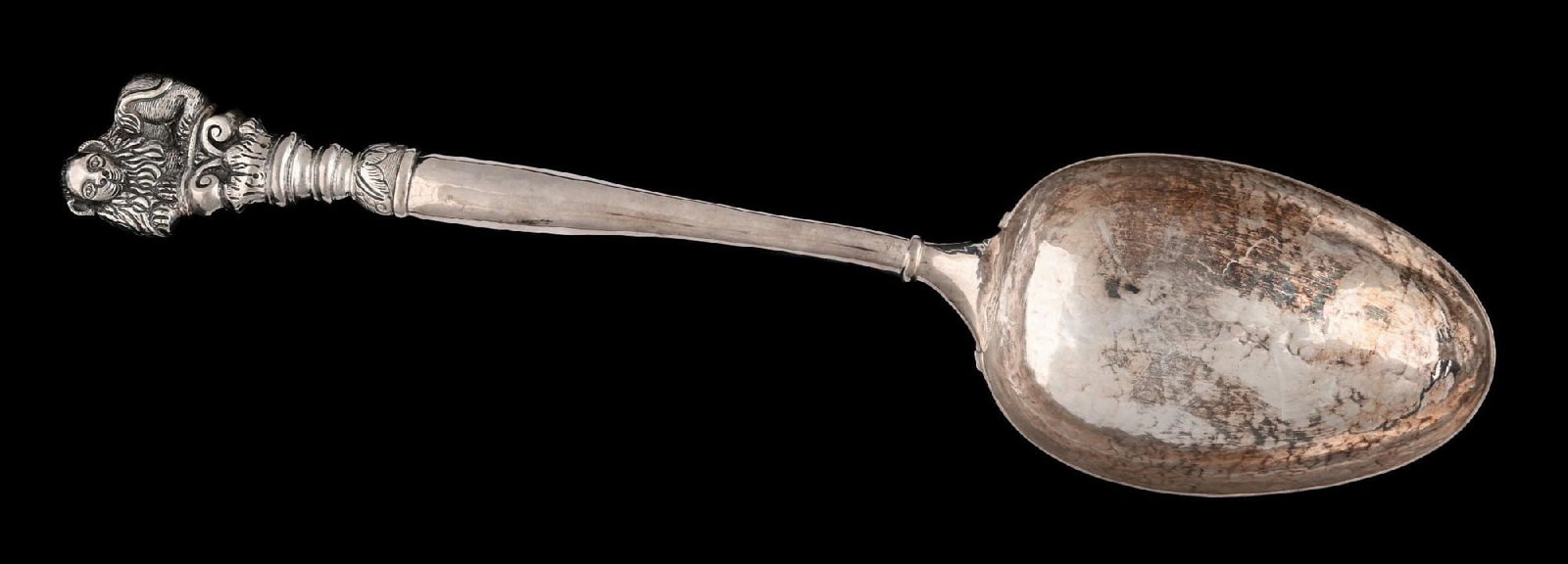 A LARGE CONTINENTAL STERLING SERVING SPOON: With hammered oval bowl, the end of the stem with the Venetian Lion of St Mark on top of a column. Length: 15-1/4". Weight: 11 ozt. Condition: Dimensions:
