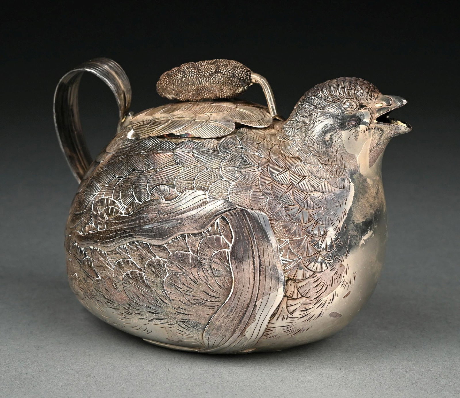 A CHINESE SILVER TEAPOT: In the form of a Hen, chased with feathers and with an open beak for the spout. Character mark under base. Length: 5-1/2". Weight: 11.7 ozt. Condition: Dimensions: