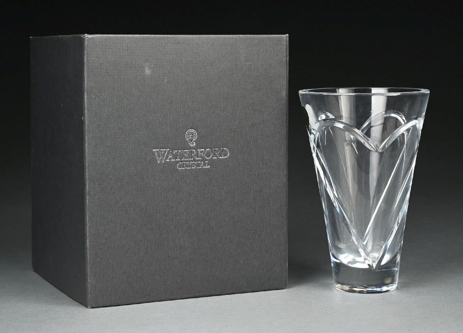 WATERFORD LEAD CRYSTAL WISHES ROMANCE TAPERED FORM VASE WITH BOX: C. 2000s. A Waterford Crystal “Wishes Romance” tapered vase featuring the distinctive heart motif from the Wishes collection. The vase displays a flared tapered form with deeply cut inters