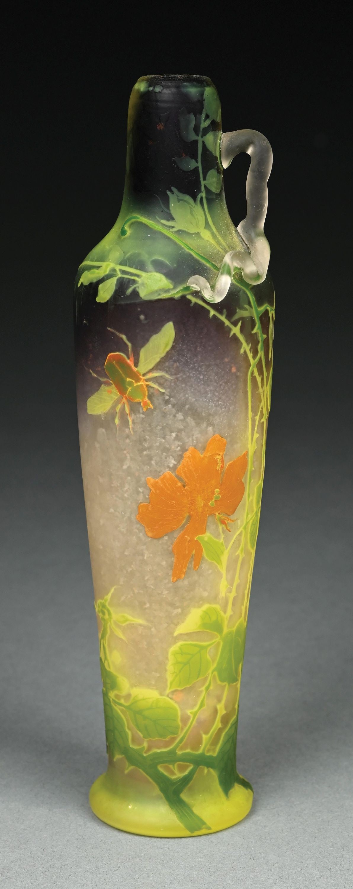 MULLER FRERES ACID ETCHED CAMEO VASE: A beautiful cameo-cut floral vase by Muller Freres. The 9-1/2" tall vase has a frosted background in shades of cream, purple, and green. In the foregound are cameo-cut leaves and flowers, as well as a
