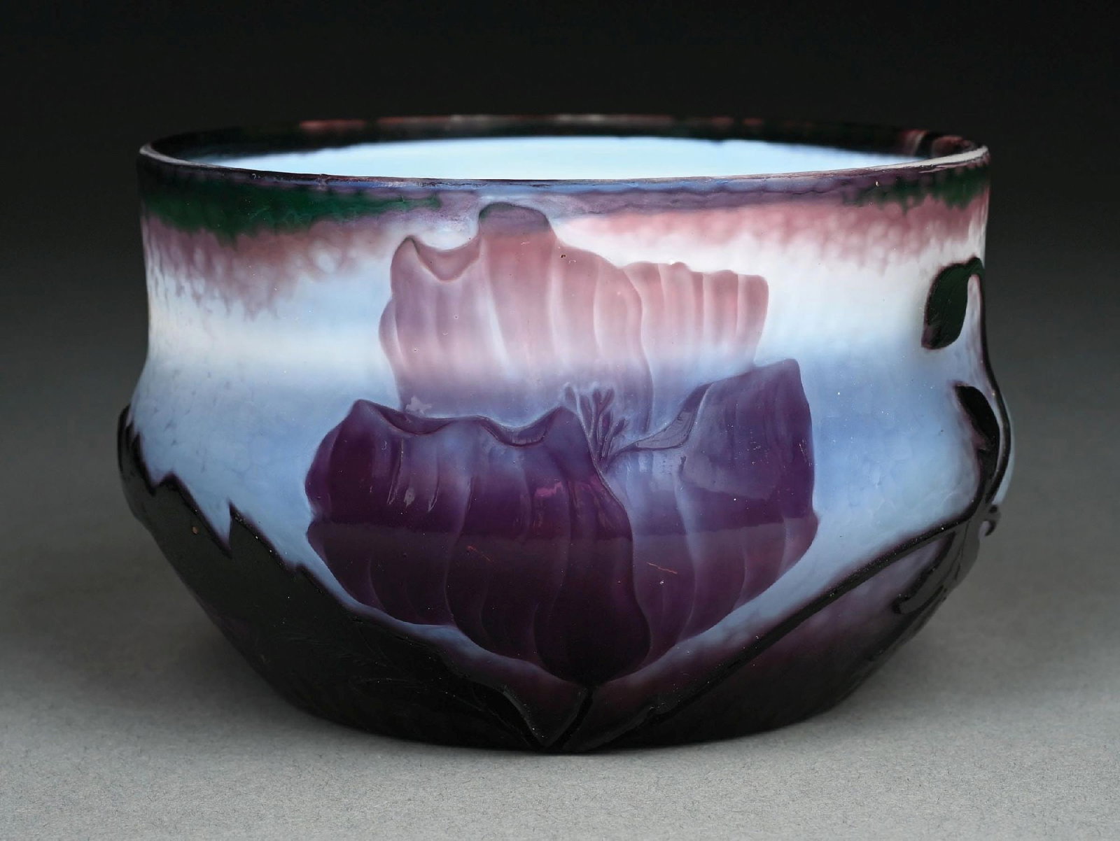 DAUM CAMEO-CUT PURPLE GLASS BOWL: A beautiful cameo-cut glass bowl by Daum Nancy. The 5-1/2" diameter bowl features a frosted purple background with pock mark motif. The bowl is decorated with cameo-cut flowers in purple. Underside is