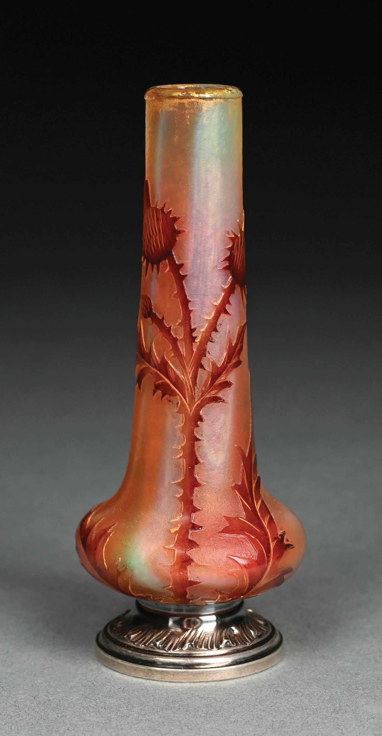 DAUM CAMEO CABINET VASE W/ SILVER MOUNT: A beautiful glass and silver mount cameo vase by Daum Nancy. The 5-1/4" tall vase has bulbous form with elongated neck. The vase has a background of orange, yellow, and pink frosted glass with cameo-c