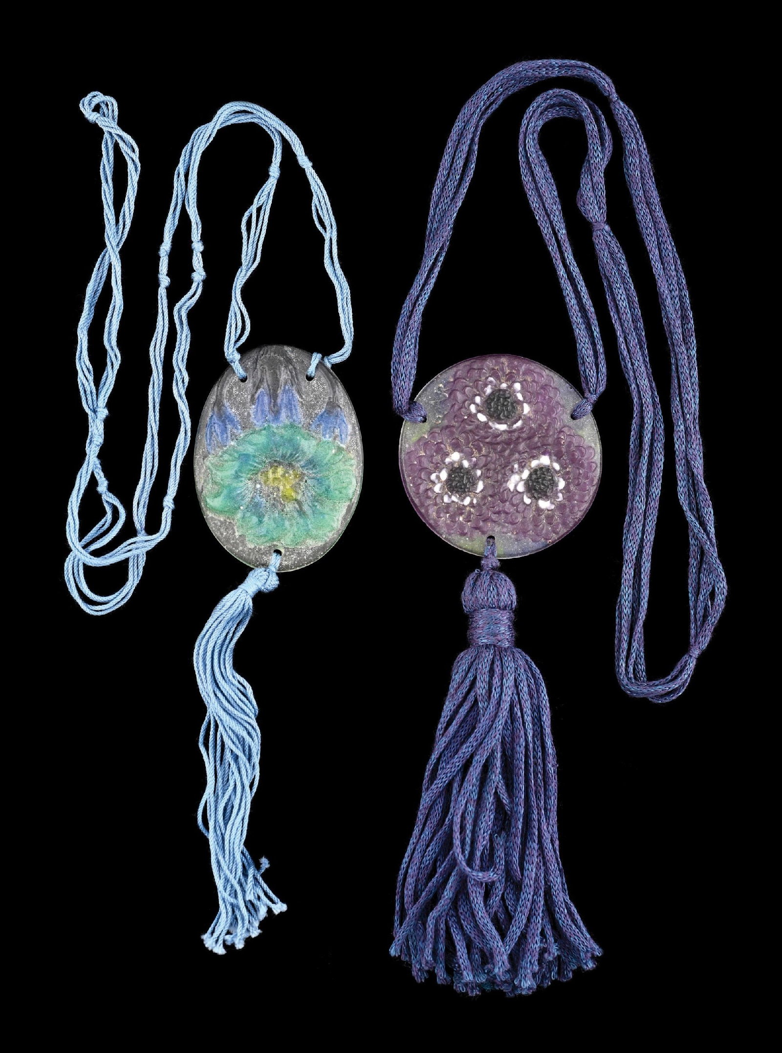 COLLECTION OF 2: G. ARGY ROUSSEAU PATE DE VERRE PENDANTS: A lovely set of two Pate de Verre pendants by G. Argy Rousseau. (A) It is composed of a frosted white background with three Pate de Verre flowers in purple. The pendant is signed "GAR." and has purple