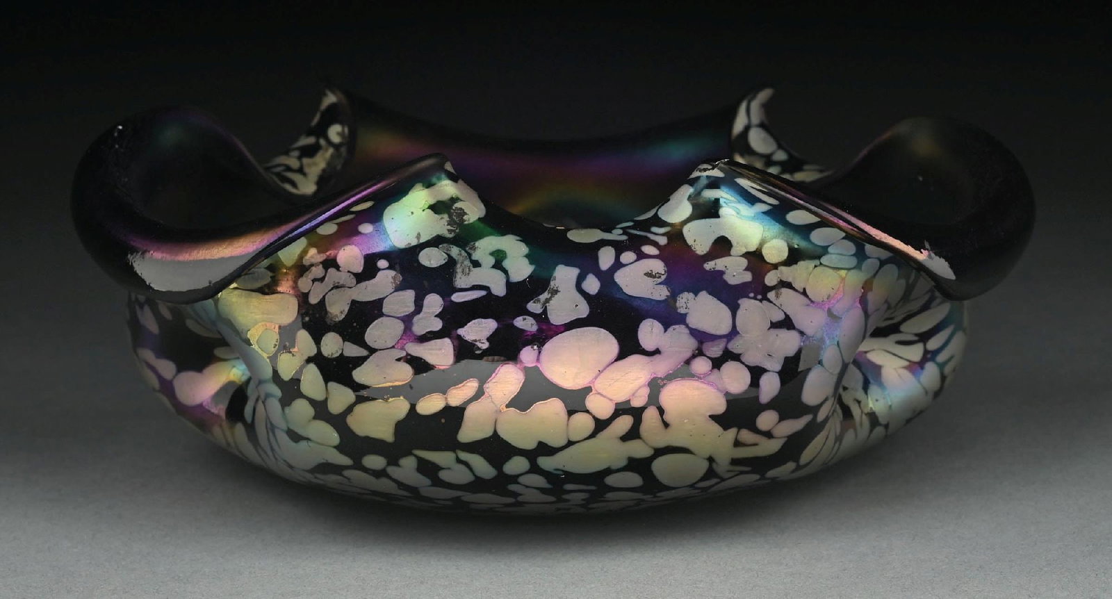 RUFFLED IRIDESCENT ART GLASS BOWL ATTRIBUTED TO LOETZ: A beautiful Art Nouveau art glass bowl attributed to Loetz. The 9" diameter bowl has a ruffled mouth and composed of purple iridescent glass with beautiful oil spot pattern throughout. Free of cracks 