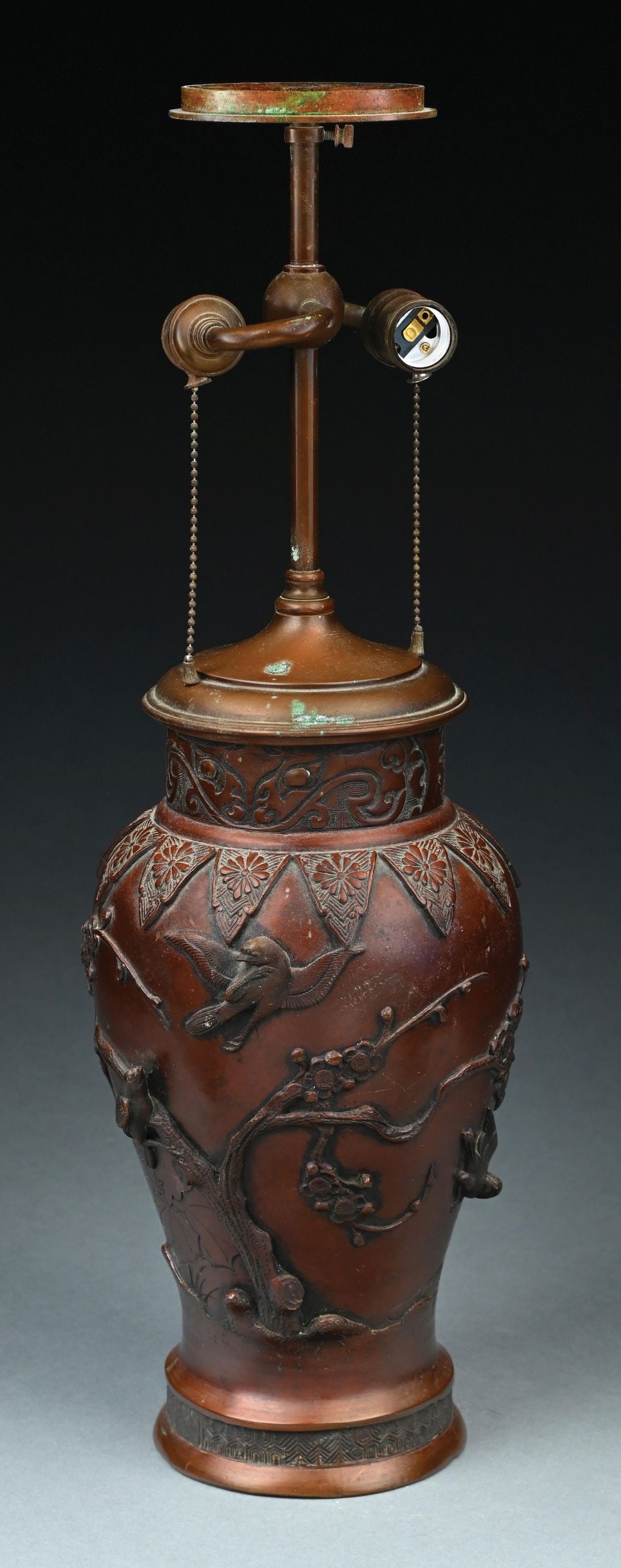 BRONZE JAPANESE LAMP BASE W/ BIRD MOTIF: A beautiful bronze oriental lamp base with bird motif. The two-socket bronze base features raised branches and birds throughout. Condition: (Very Good). Dimensions: 8" Dia. x 25 - 1/4" T.