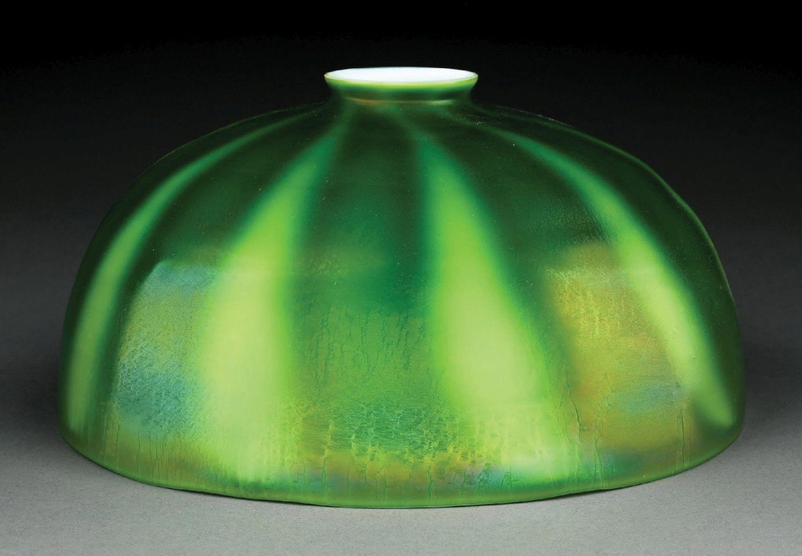 TIFFANY STUDIOS FAVRILE GLASS GREEN SHADE: A beautiful green favrile glass lamp shade by Tiffany Studios. The 10" diameter L-shaped shade has a beautiful banded pattern with alternating bands of dark and light green, with subtle iridescence