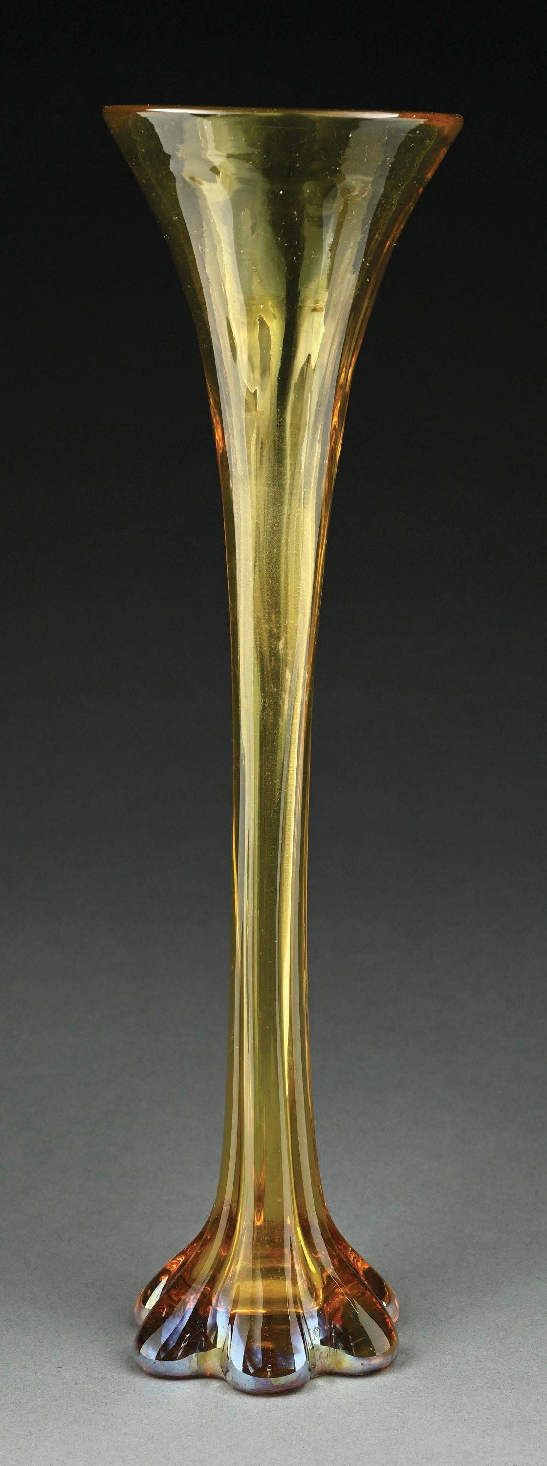 TIFFANY STUDIOS AMBER GLASS TRUMPET VASE: A lovely glass vase by Tiffany Studios. The 14" tall vase has amber-colored glass with subtle iridescence, most notable at the foot. The vase is signed to the underside "LCT Favrile 986T". In excellen