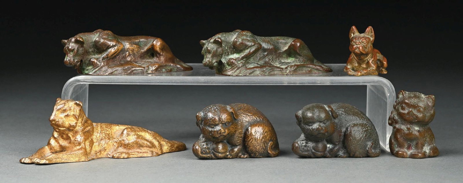 COLLECTION OF 7: BRONZE TIFFANY STUDIOS ANIMALS: A beautiful collection of 7 bronze miniature animal statues by Tiffany Studios. Includes two dogs, a bulldog, two panthers, a lion, and a cat. Condition: (Very Good). Dimensions: Largest Approx: 4 - 3