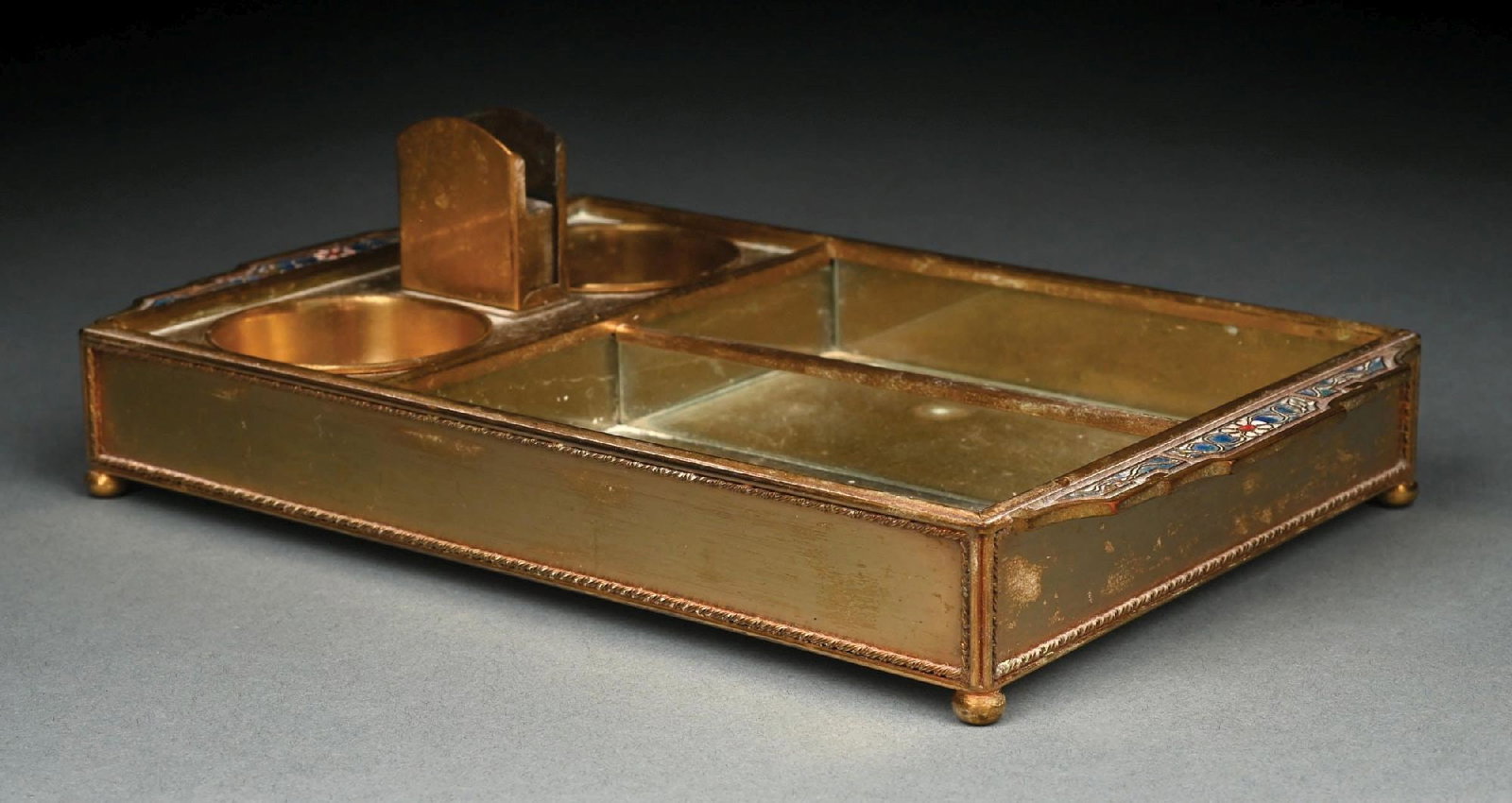 TIFFANY STUDIOS DOUBLE ASHTRAY & CIGAR HOLDER: A lovely and rare bronze Tiffany Studios double-ashtray and cigar holder. The 11-1/2" long bronze tray is finished in acid etched gold dore. It features two compartments for cigars, as well as two cir