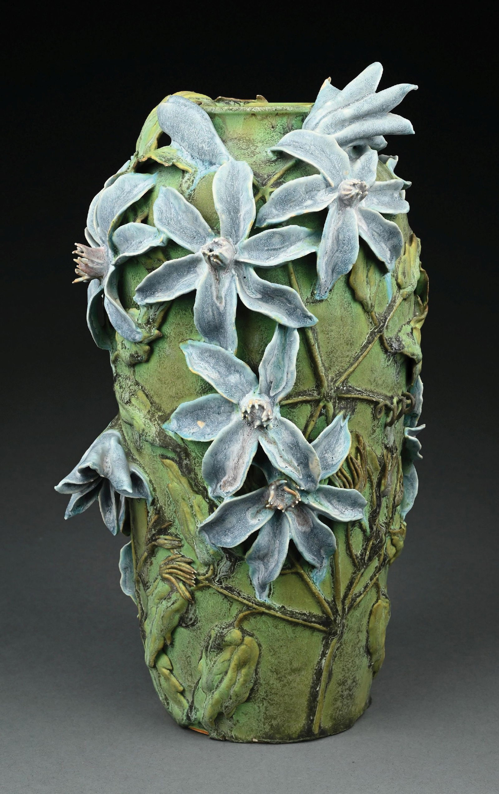 JEMERICK STUDIO POTTERY FLORAL VASE, C. 1996: Arts & Crafts Style Vase by Jemerick Studio, Saugerties, New York. The 14 inch tall matte glazed green vase with applied blue flowers and leaves is stamped with the studio mark on the underside.