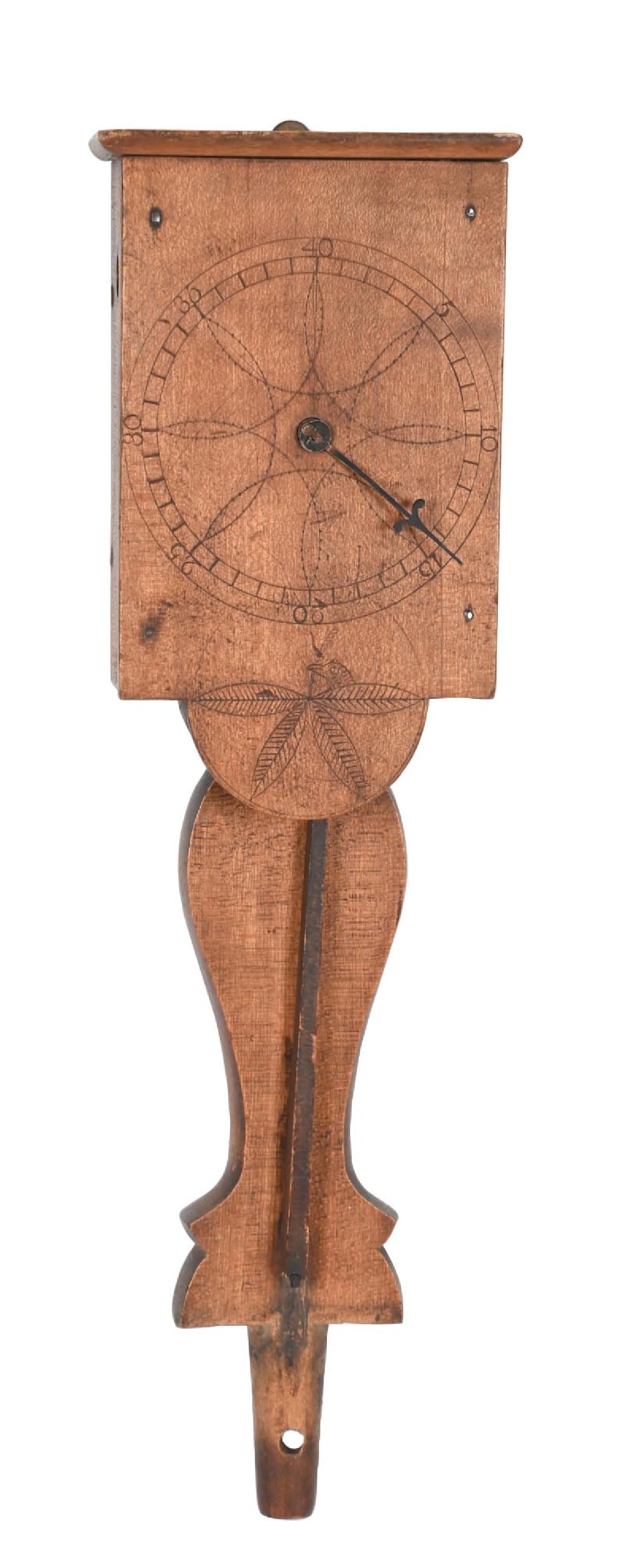 PRIMITIVE HANDMADE PENNSYLVANIA DUTCH CLINOMETER: C. 1820–1850. Primitive Pennsylvania Dutch handmade wooden clinometer with a wall-mount form with a rectangular case and extended shaped lower support. The face is hand-scribed with a circular